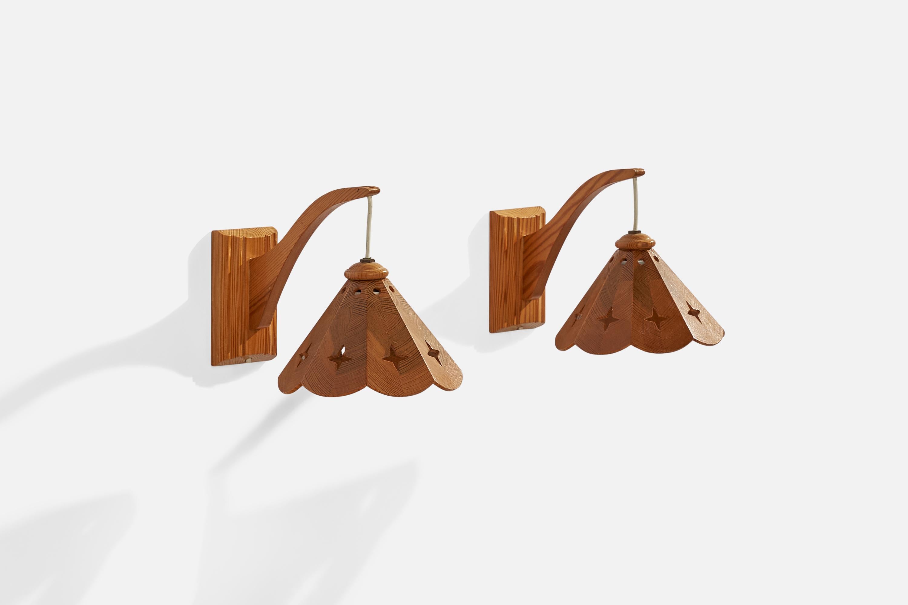  A pair of pine wall lights designed and produced in Sweden, 1970s.

Overall Dimensions (inches): 7.25” H x 6.75” W x 10” D
Back Plate Dimensions (inches): 5.25” H x 3.25” W x .75” D
Bulb Specifications: E-14 Bulb
Number of Sockets: 2
All lighting