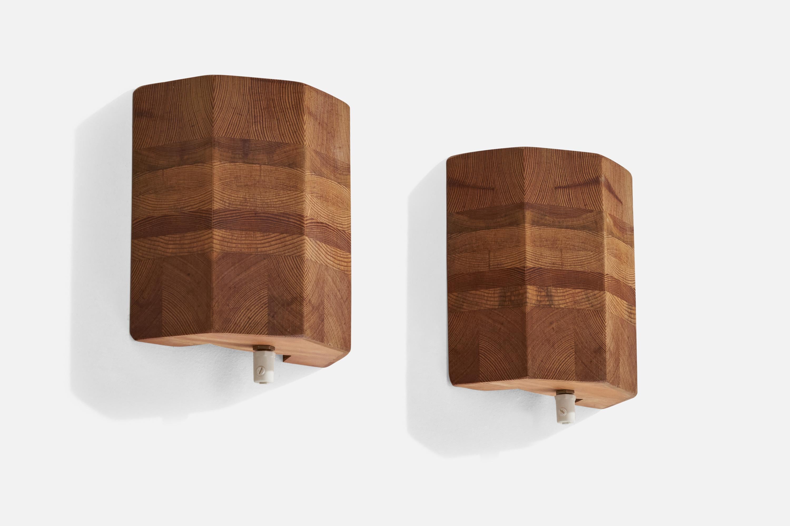 A pair of pine wall lights designed and produced in Sweden, 1970s.

Overall Dimensions (inches): 8.5” H x 6.75” W x 2.24” D
Back Plate Dimensions (inches):N/A
Bulb Specifications: E-14 Bulb
Number of Sockets: 2
All lighting will be converted for US