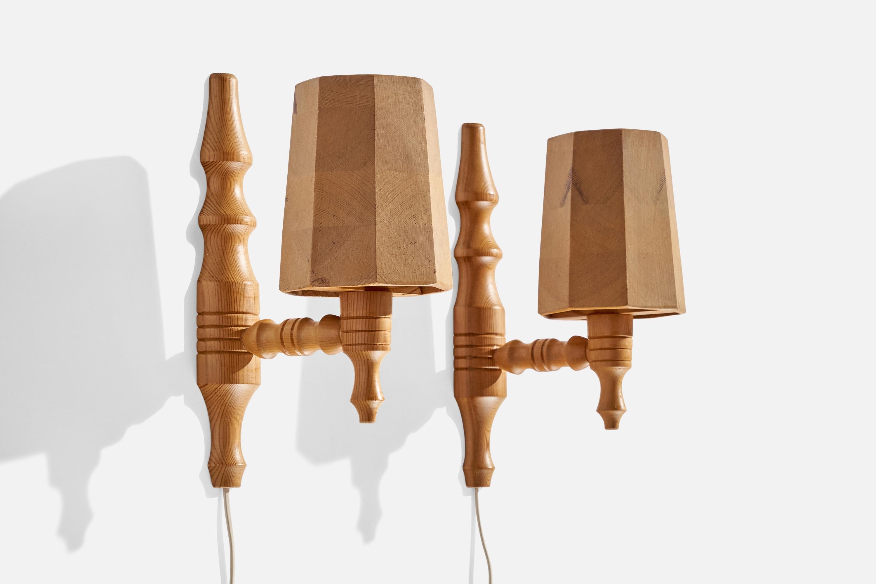 A pair of pine wall lights designed and produced in Sweden, c. 1970s.

Overall Dimensions (inches): 11.75 ” H x  4.875” W x  7.875“D
Back Plate Dimensions (Inches):  11.75” H x 2.25” W x 1.25” D
Bulb Specifications: E-14 Bulbs
Number of Sockets (per