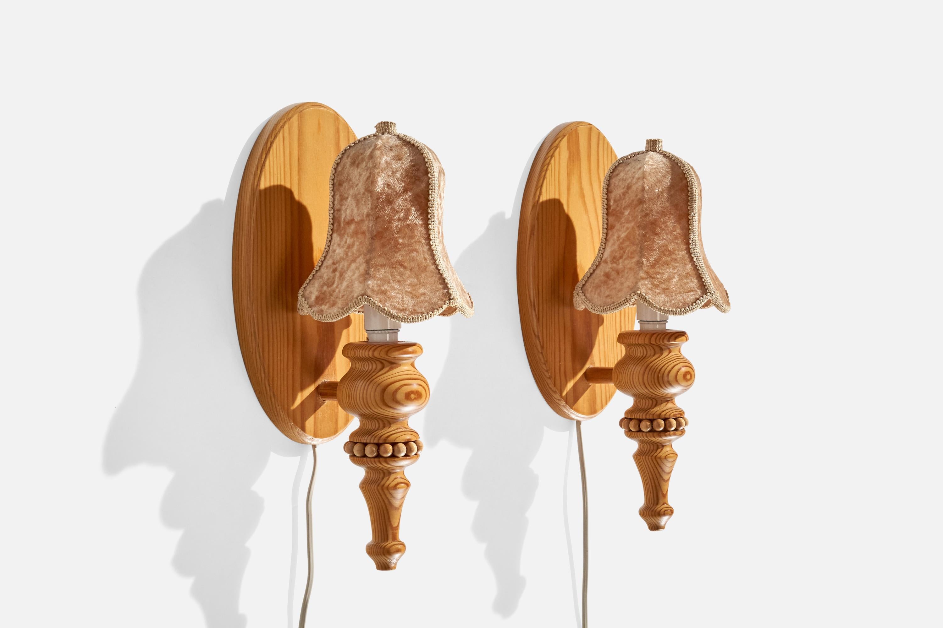 A pair of pine and brown velvet wall lights designed and produced in Sweden, c. 1970s

Overall Dimensions (inches):  13.75” H x 5.875 ” W x  5.25“D

Back Plate Dimensions (Inches):  10.25” H x 6” W x 5.125” D

Bulb Specifications: E-14 Bulbs

Number
