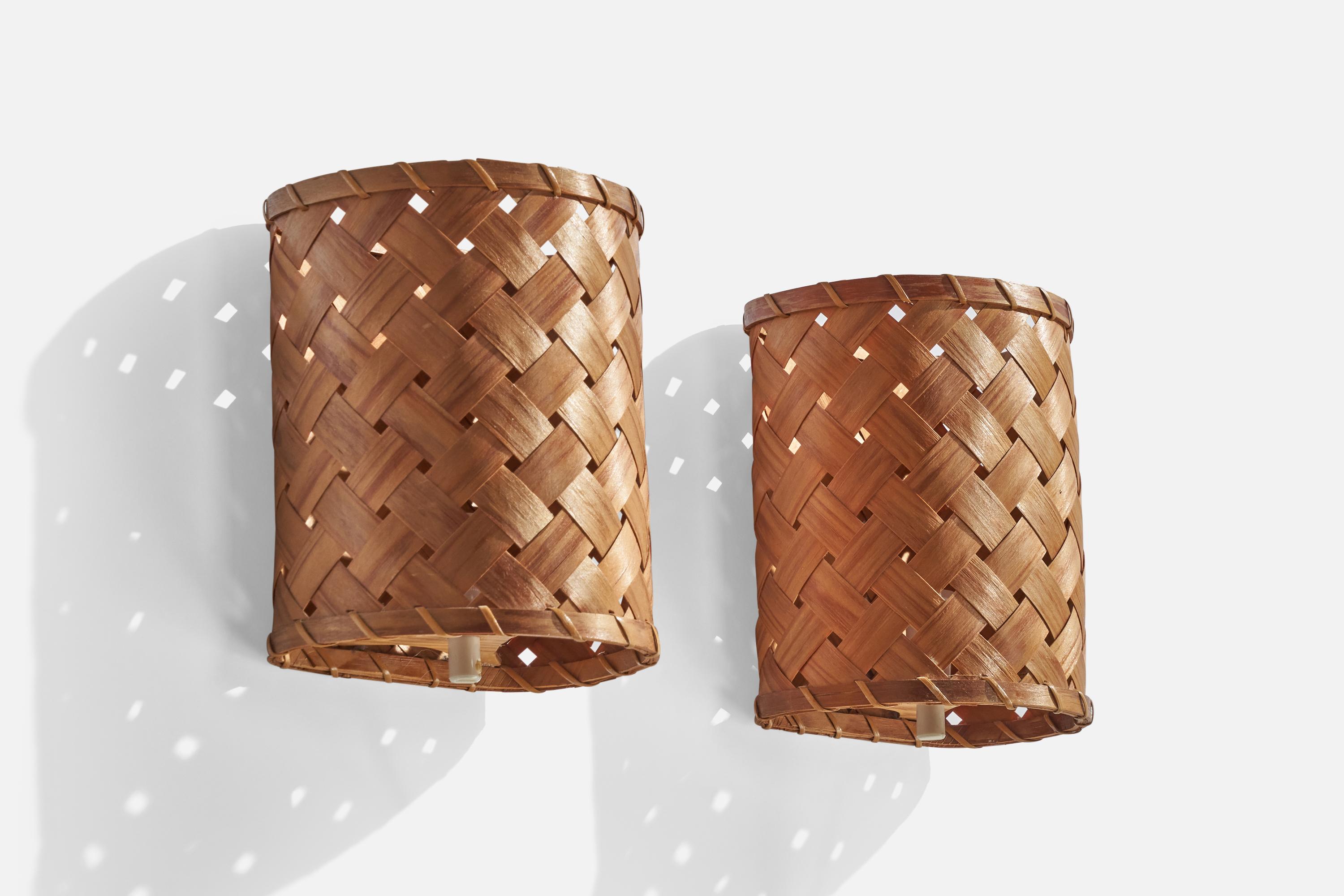 A pair of woven pine veneer wall lights designed and produced in Sweden, 1960s.

Overall Dimensions (inches): 9.5” H x 7.5”  W x 5.5”  D
Back Plate Dimensions (inches): N/A
Bulb Specifications: E-14 Bulb
Number of Sockets: 1
All lighting will be