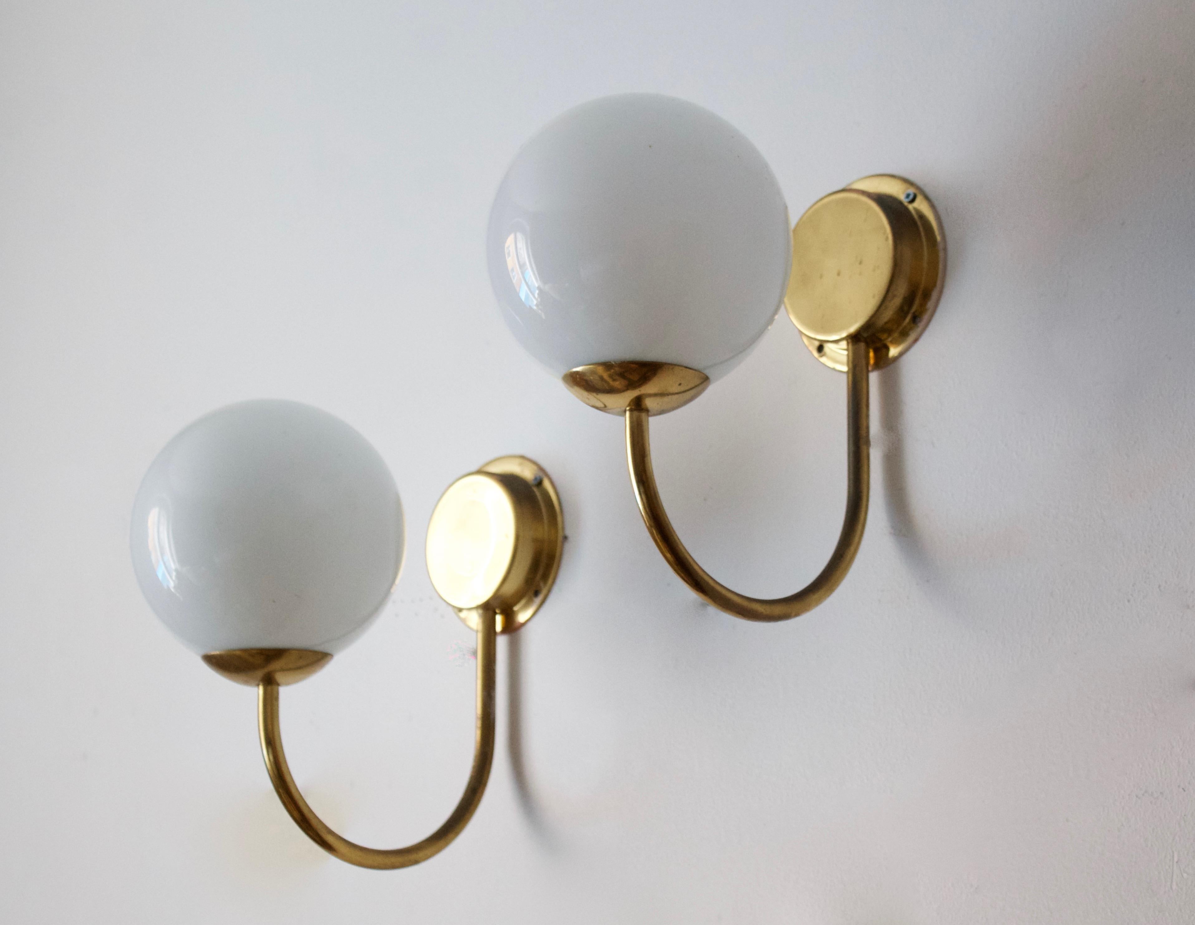 A pair of wall lights / sconces. Designed and produced in Sweden, c. 1950s. In brass, with original milk glass diffusers / lampshades.

Other designers of the period include Hans Bergström, Paavo Tynell, Lisa Johansson-Pape, Alvar Aalto, and Josef