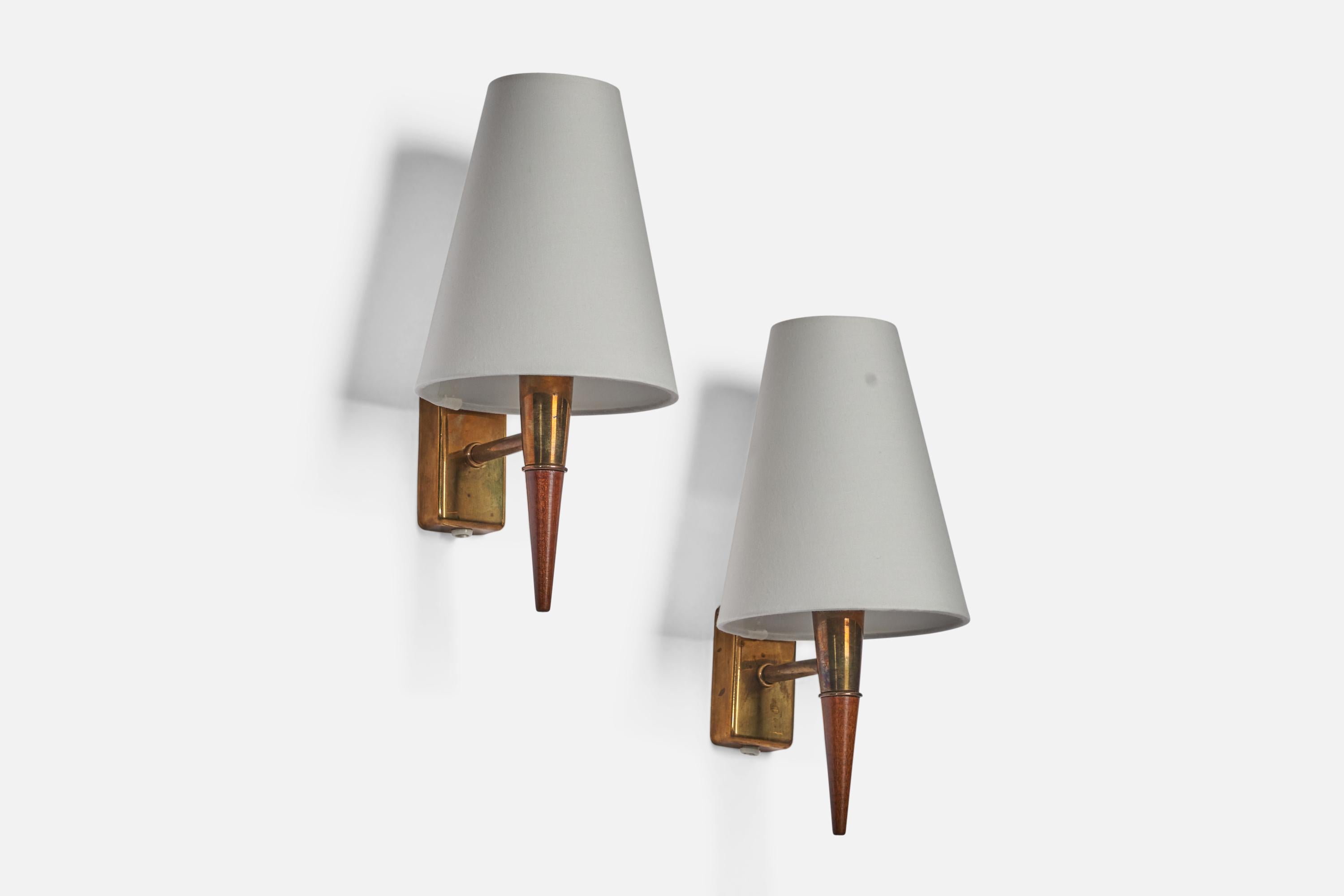 A pair of teak, brass and white fabric wall lights designed and produced in Sweden, 1950s.

Overall Dimensions (inches): 11.75” H x 5.5” W x 6.5” D
Back Plate Dimensions (inches): 3.15” H x 1.75” W x 0.8” D
Bulb Specifications: E-14 Bulb
Number of