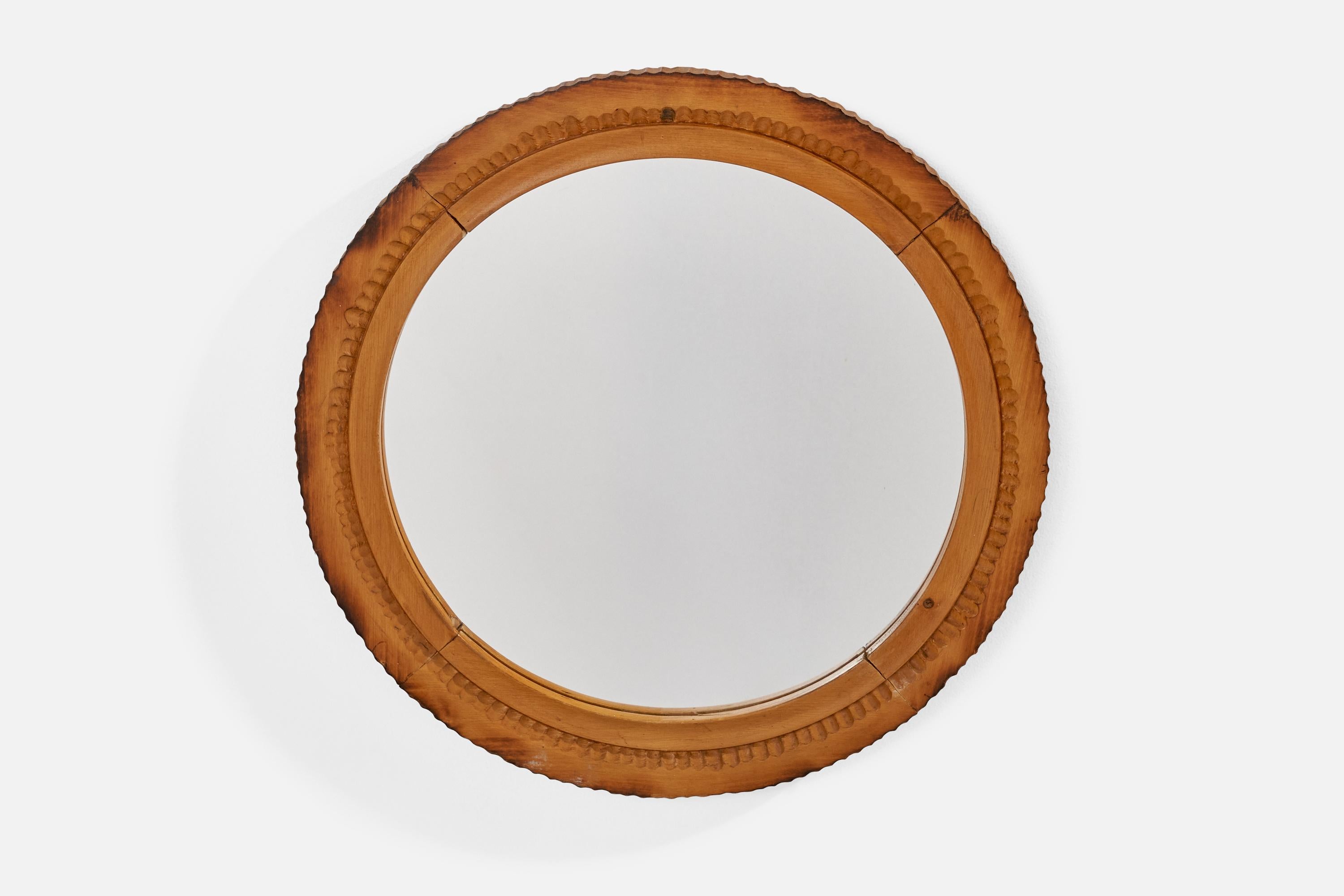 A round burnished birch wall mirror, designed and produced in Sweden, 1970s.