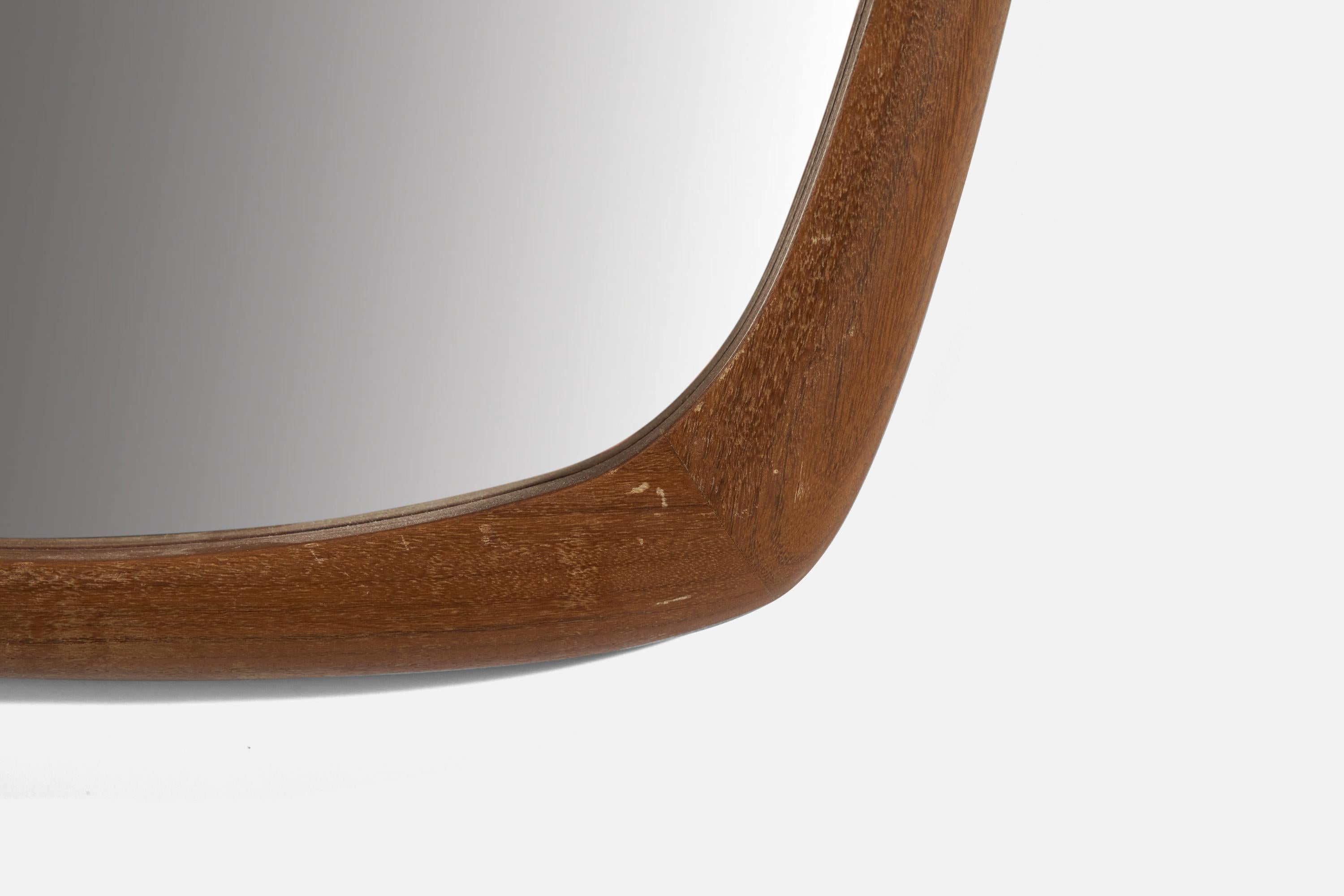 A wall mirror, designed and produced in Sweden, c. 1950s. In finely carved solid teak. Original mirror glass.

Width measured from the widest point.