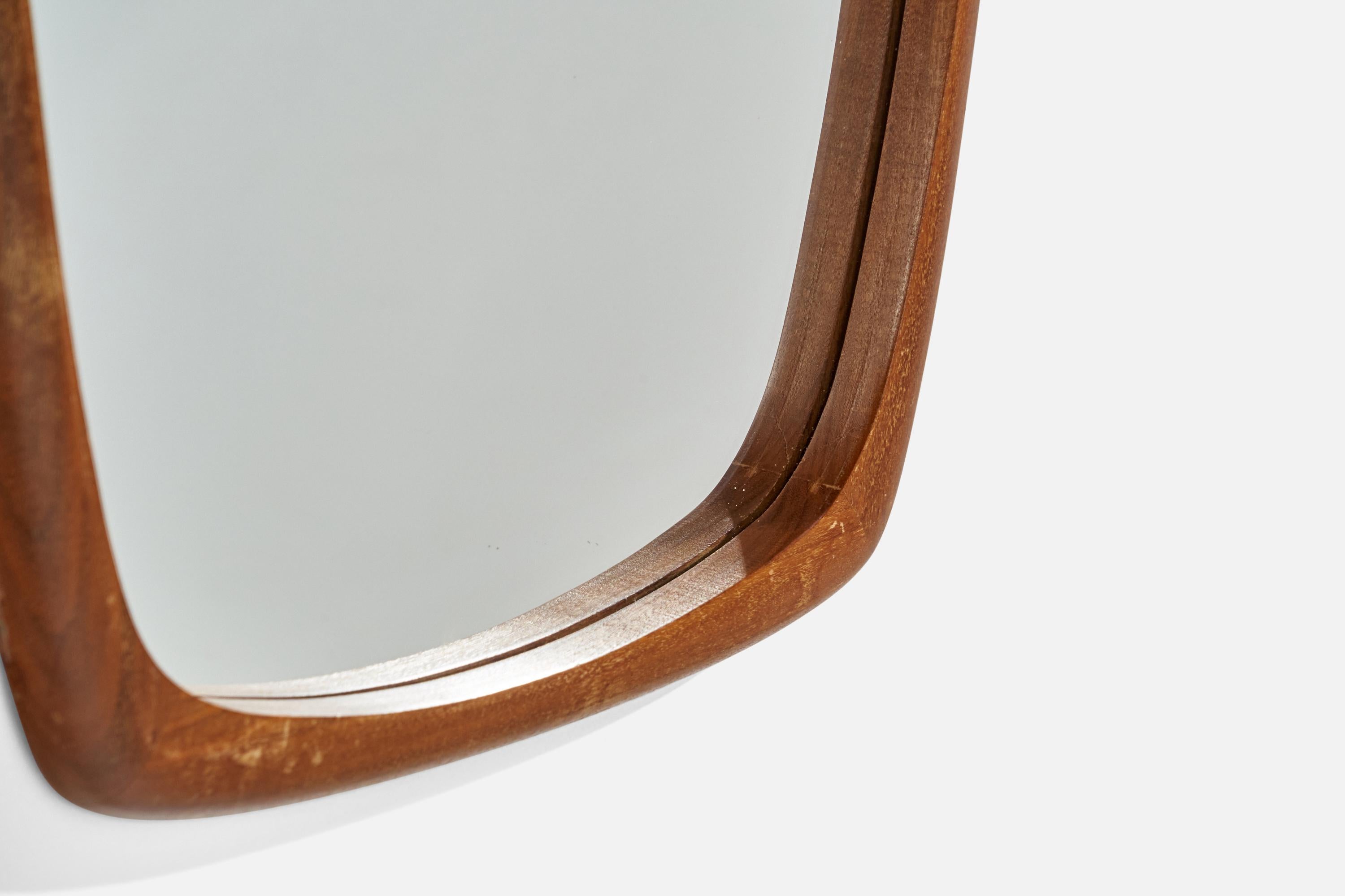 A wall mirror, designed and produced in Sweden, c. 1950s. In finely carved solid teak. Original mirror glass.

Width measured from the widest point.