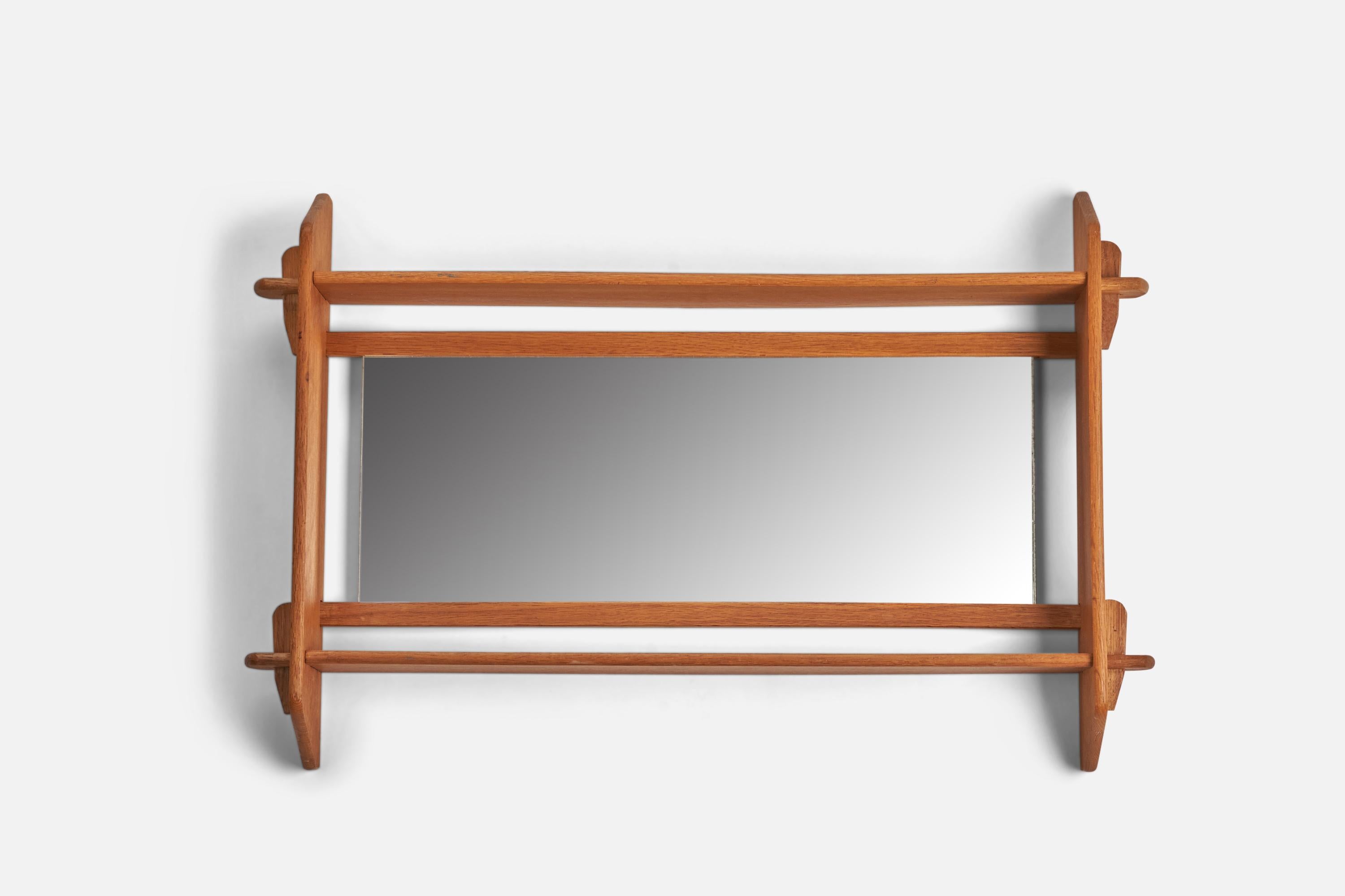 An oak wall mirror designed and produced by a Swedish Designer, Sweden, 1960s.
