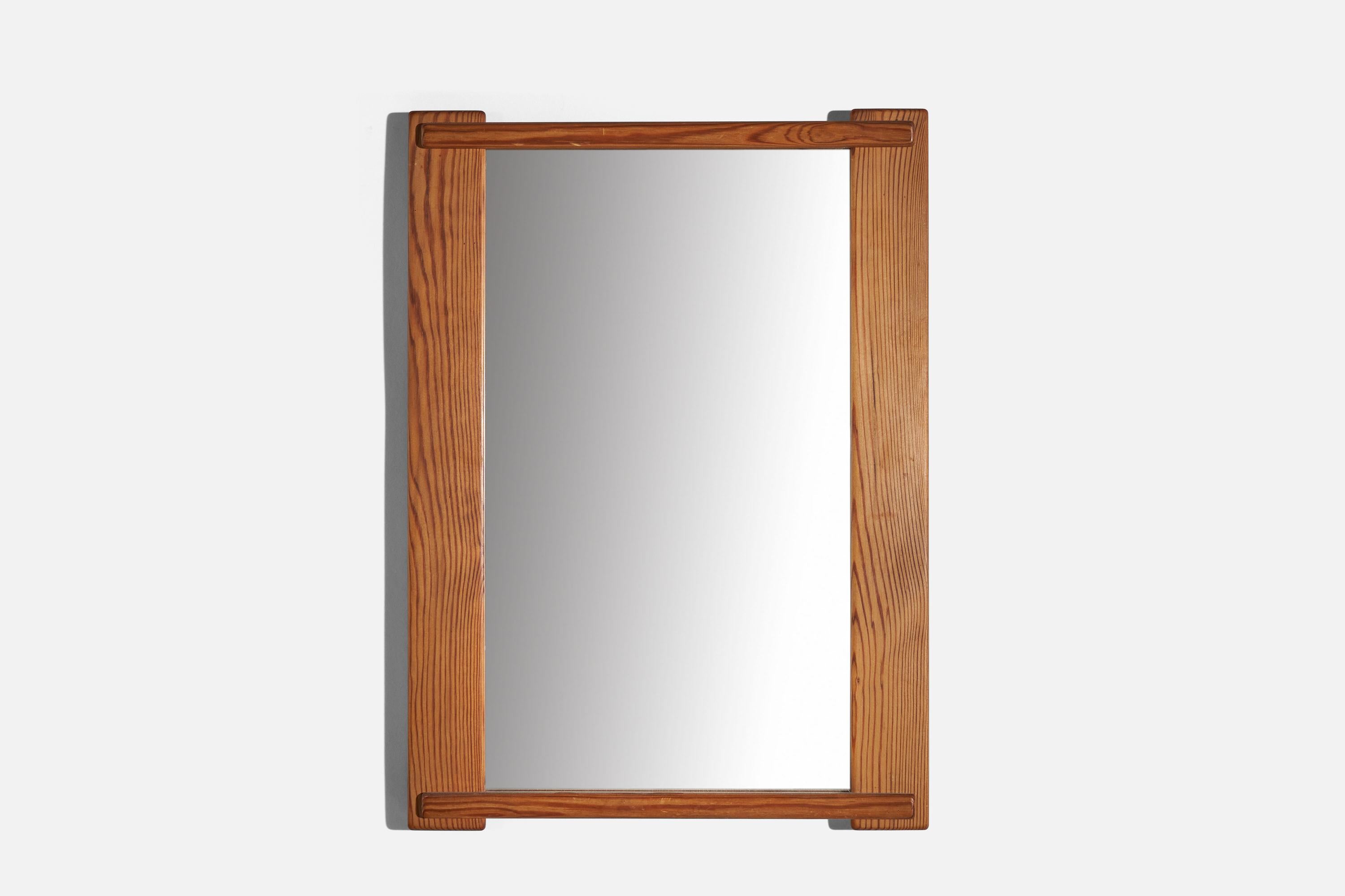 A pine wall mirror designed and produced in Sweden, 1970s.
   