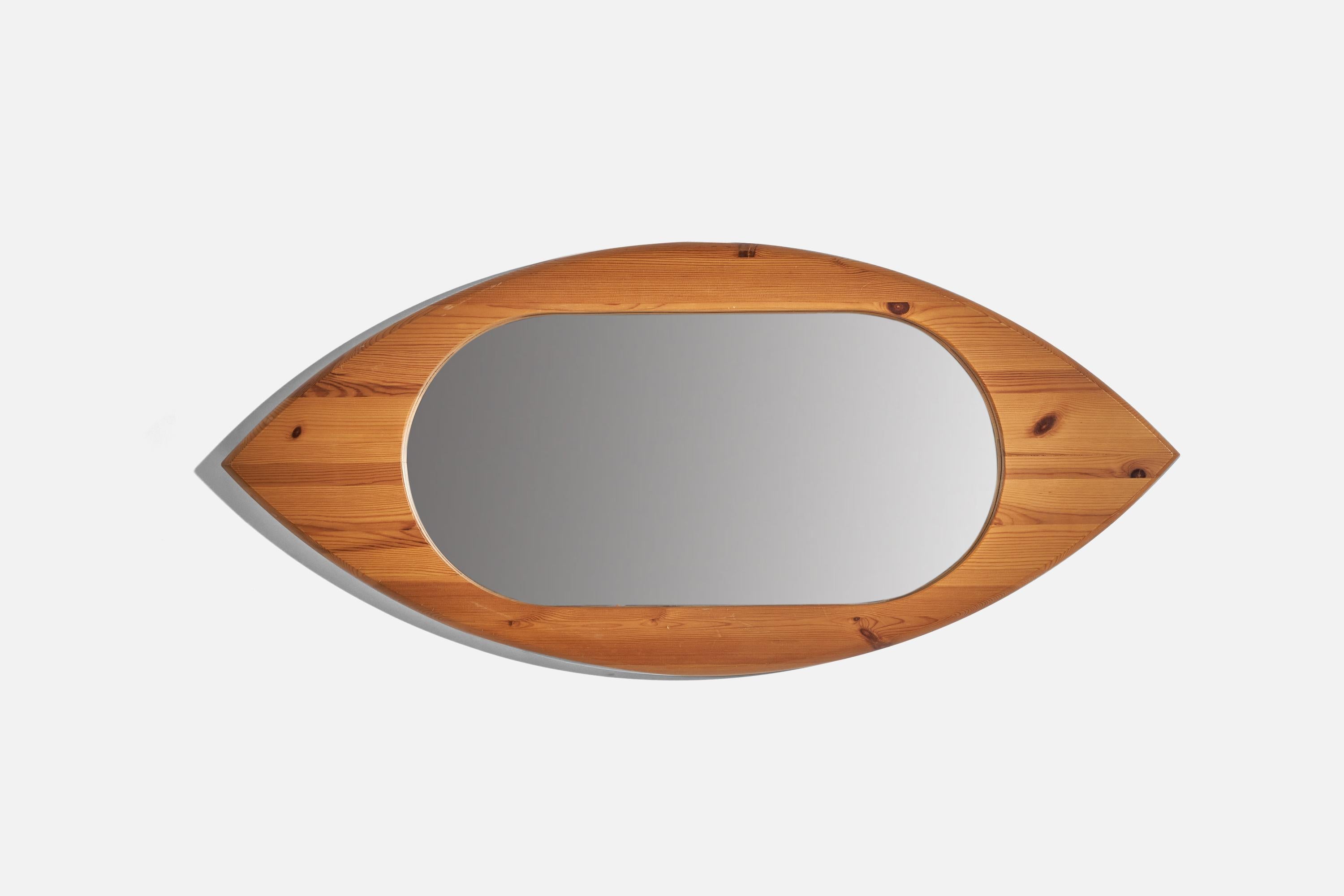 A pine wall mirror designed and produced in Sweden, 1970s.
  
