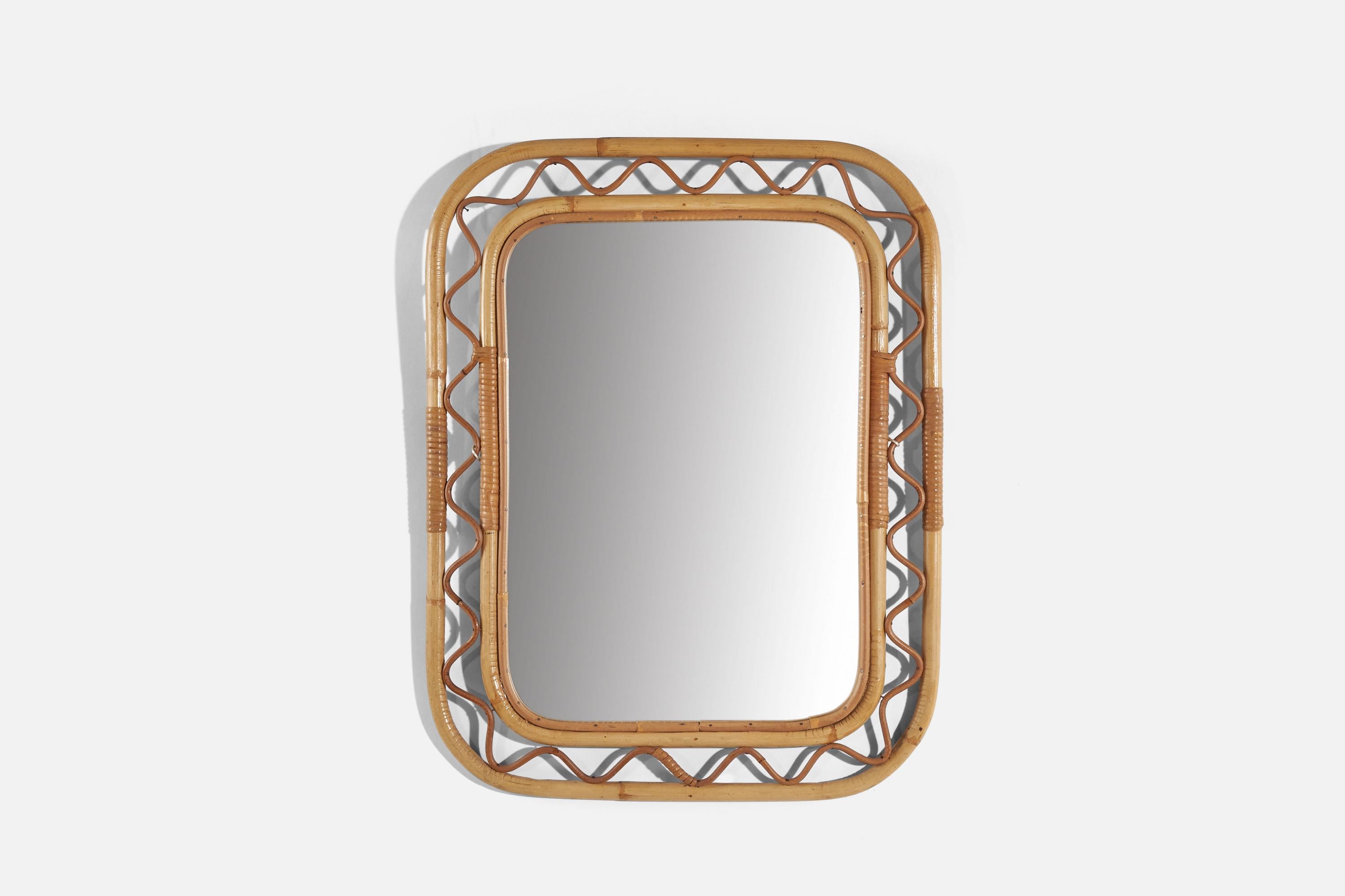A bamboo and rattan wall mirror designed and produced in Sweden, c. 1950s-1960s. 


