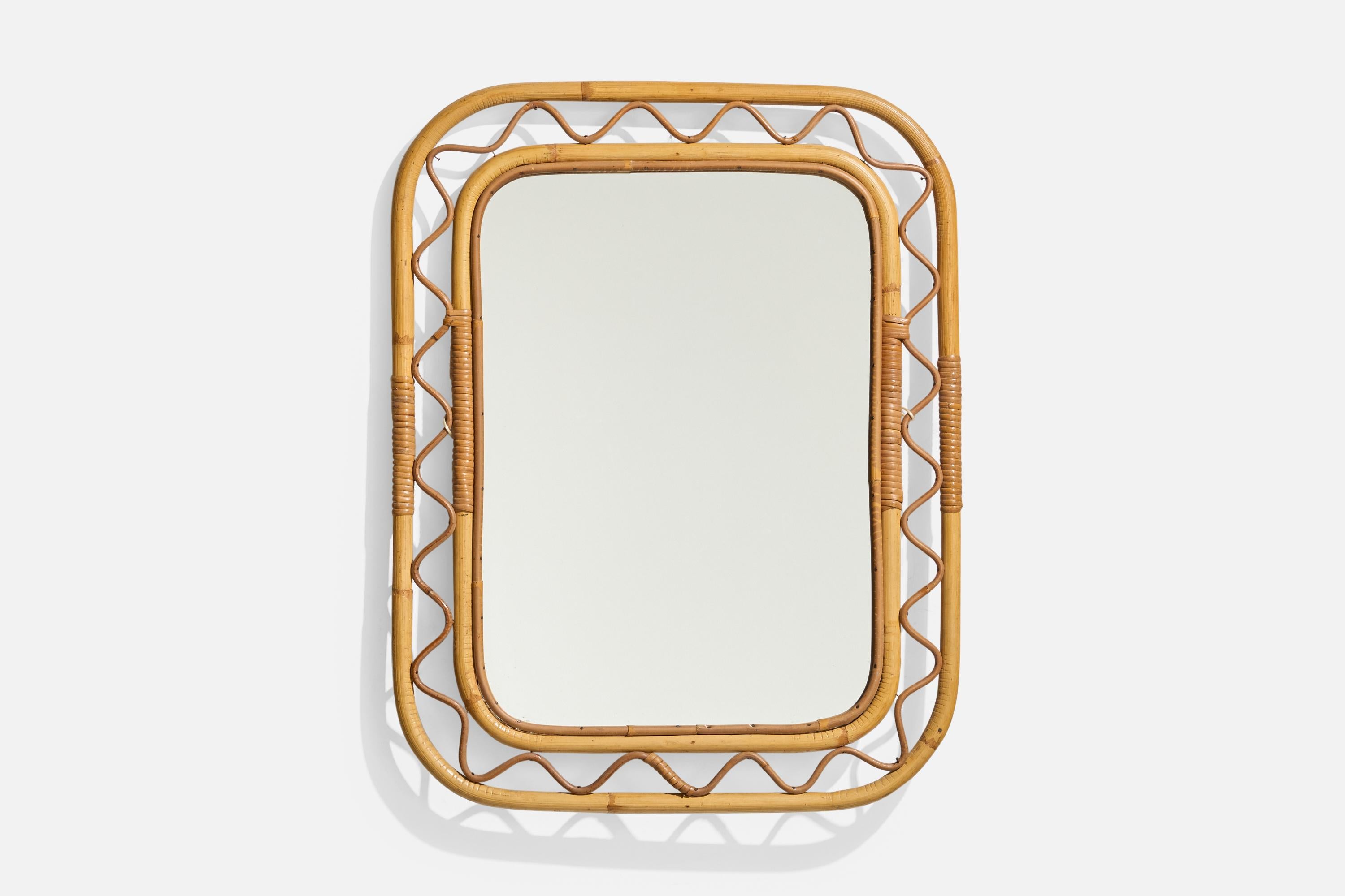 A bamboo and rattan wall mirror designed and produced in Sweden, c. 1950s-1960s. 


