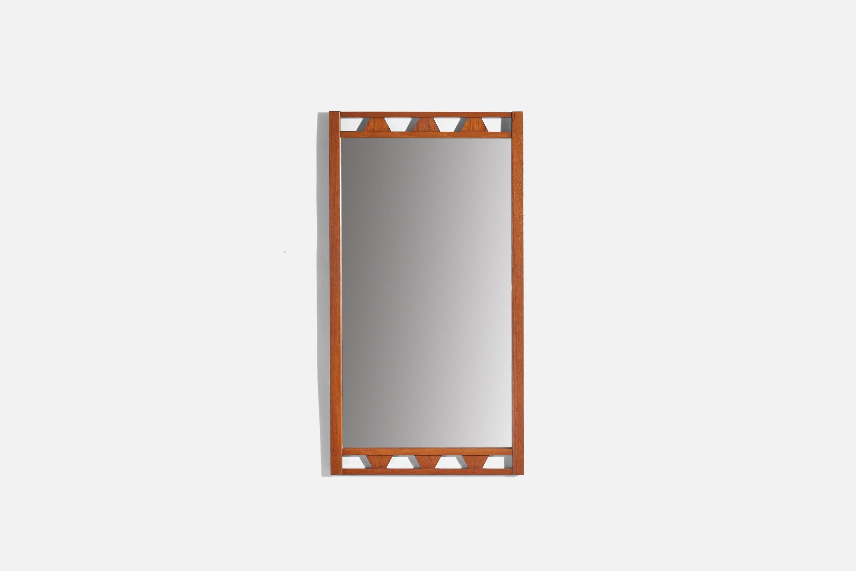 A teak wall mirror designed and produced in Sweden, 1950s.