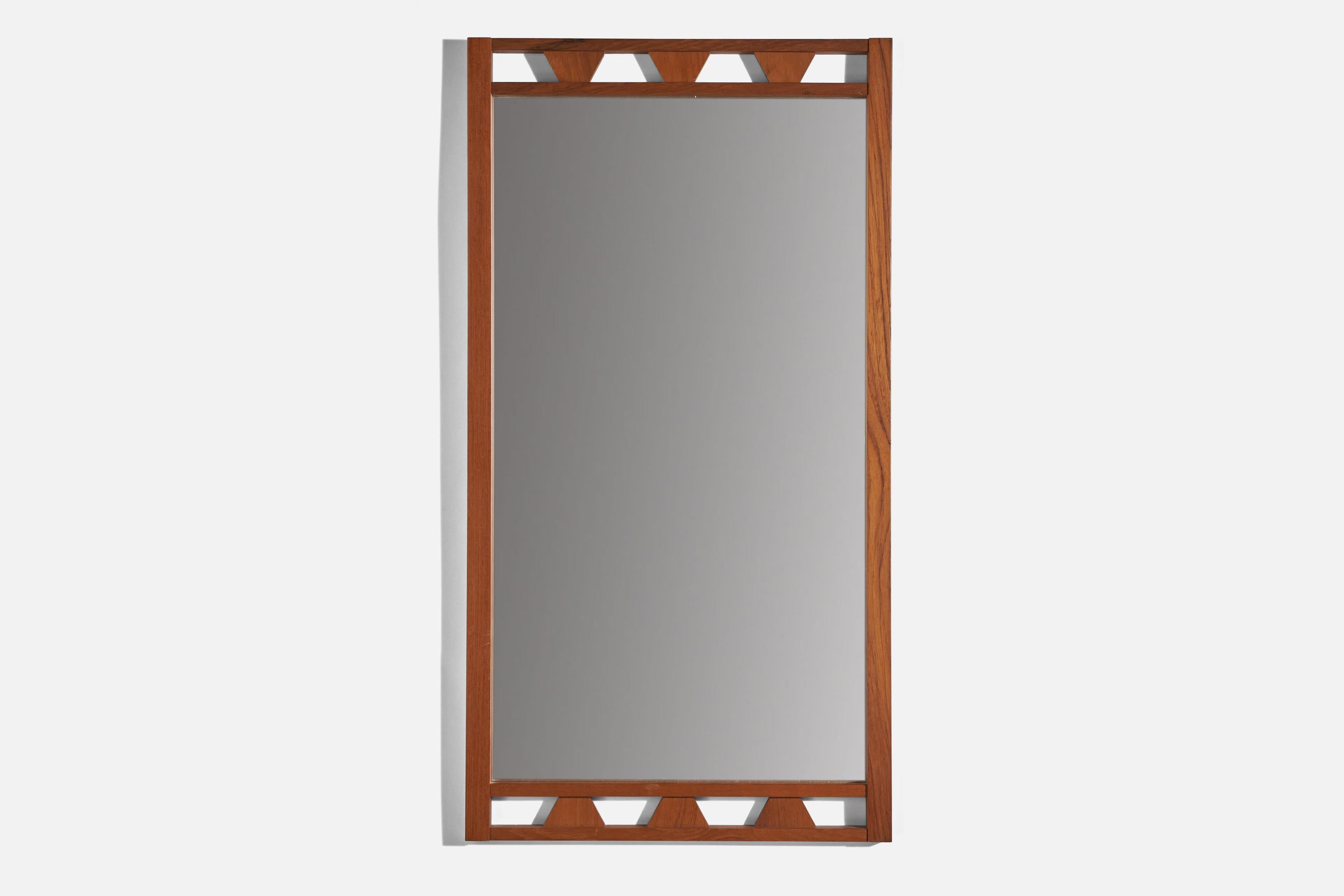 A stained oak wall mirror designed and produced in Sweden, 1950s. 
