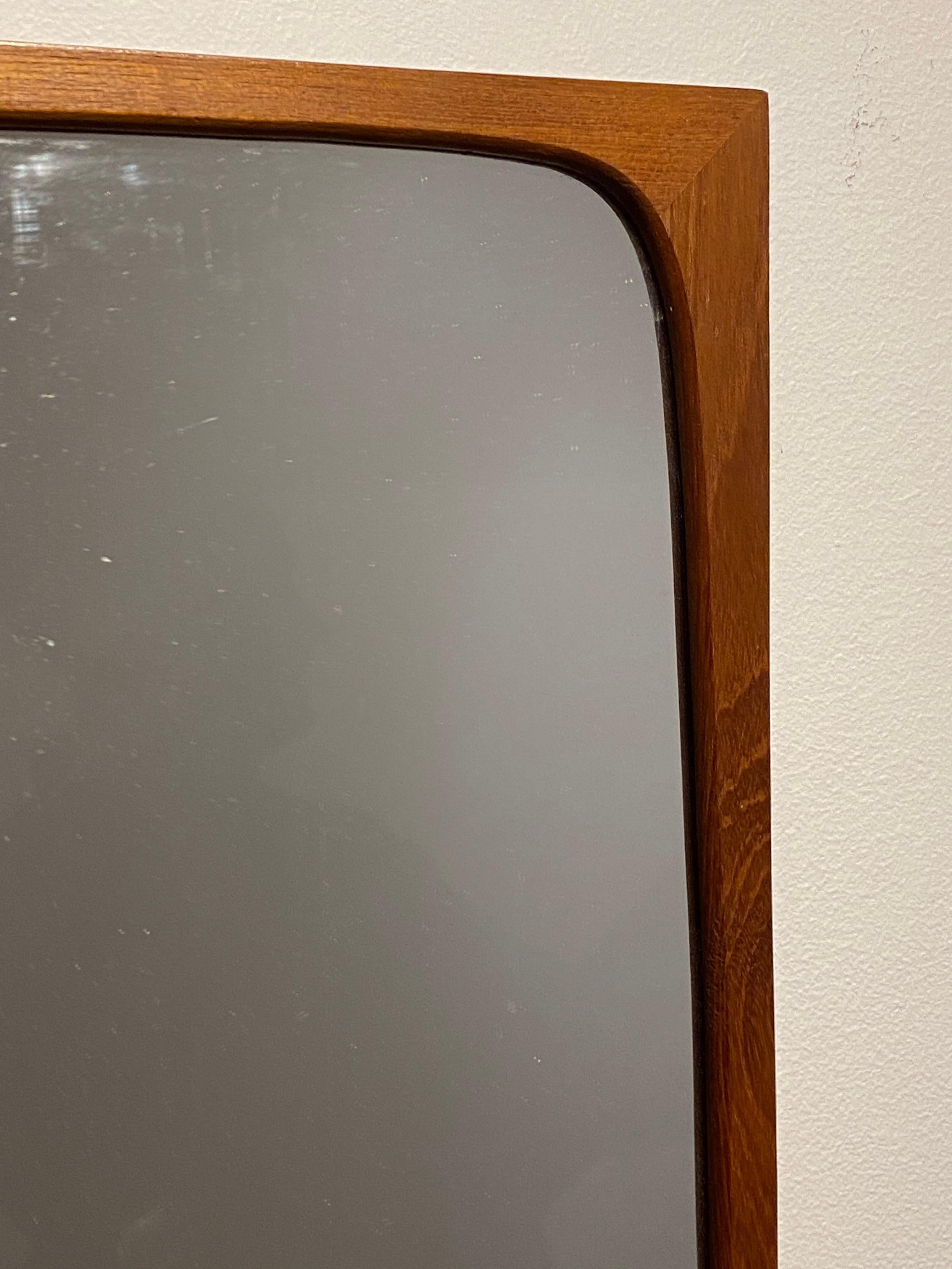 A teak wall mirror designed and produced in Sweden, 1950s. 