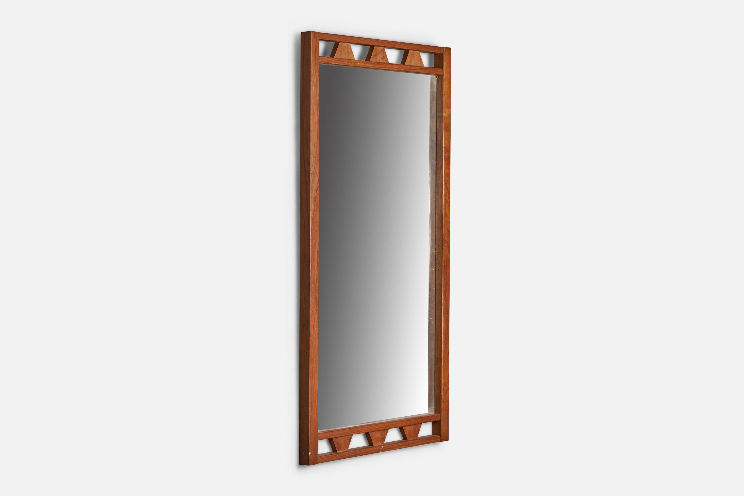 A teak wall mirror designed and produced in Sweden, 1950s.