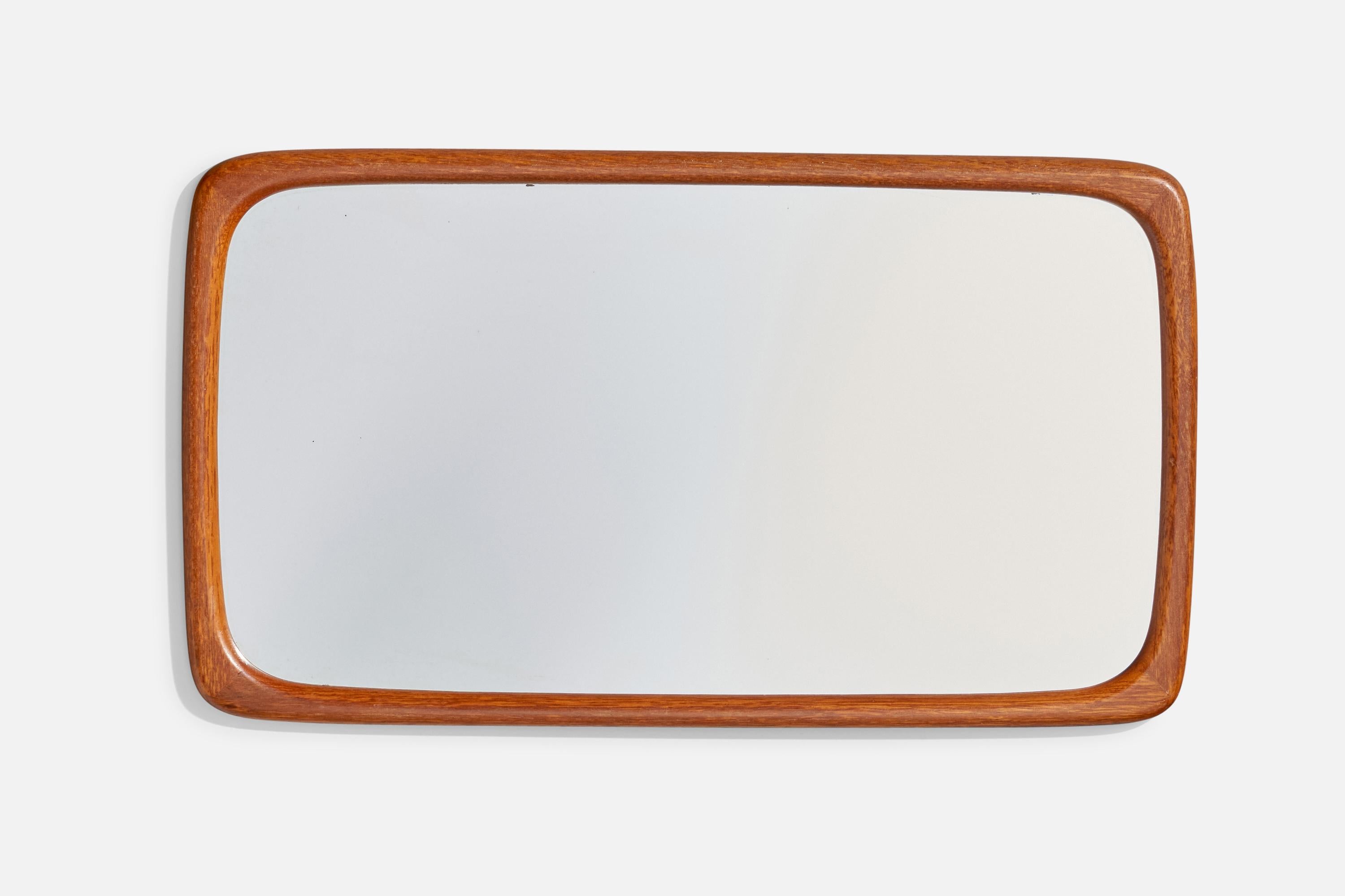 A teak wall mirror designed and produced in Sweden, c. 1950s.

