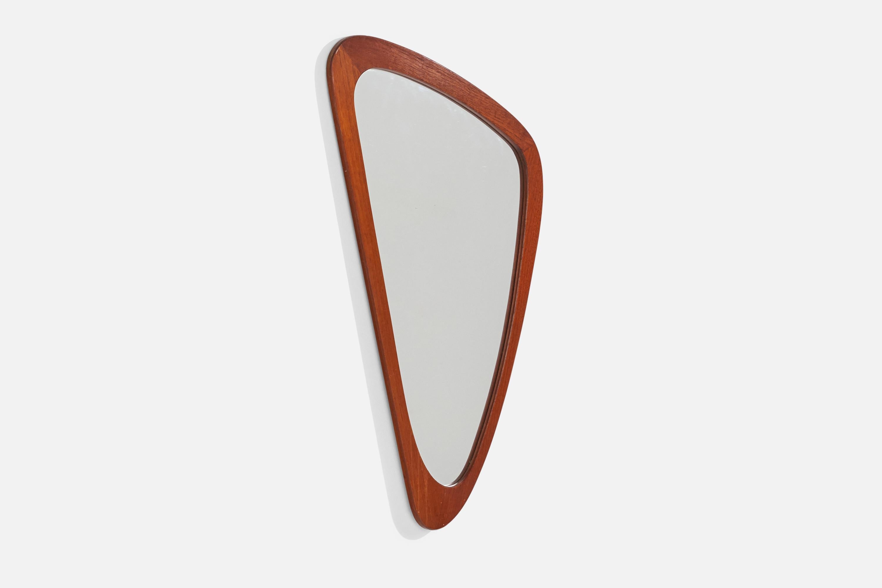 An organic teak wall mirror designed and produced in Sweden, c. 1960s.