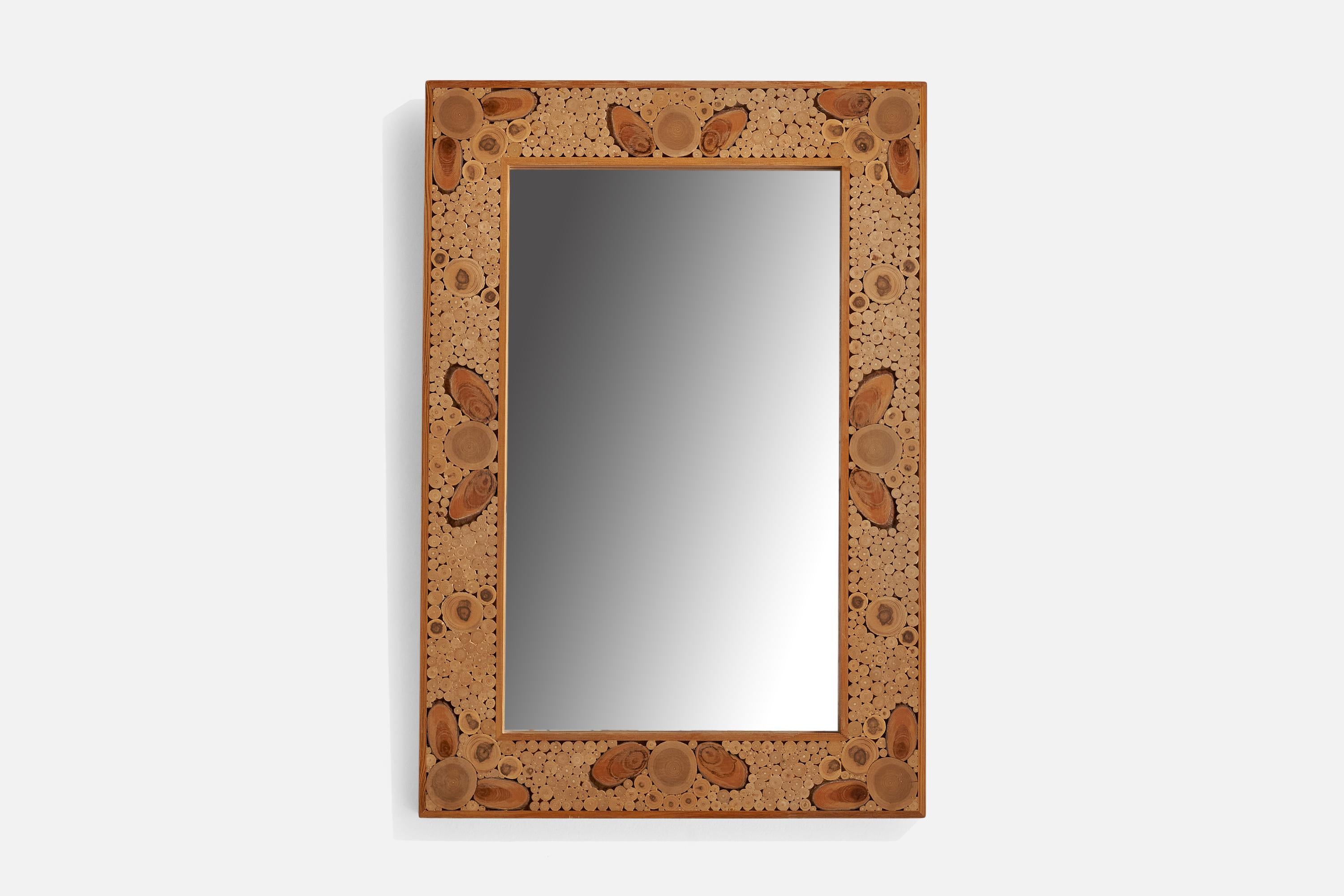 A wood wall mirror designed and produced in Sweden, 1975.