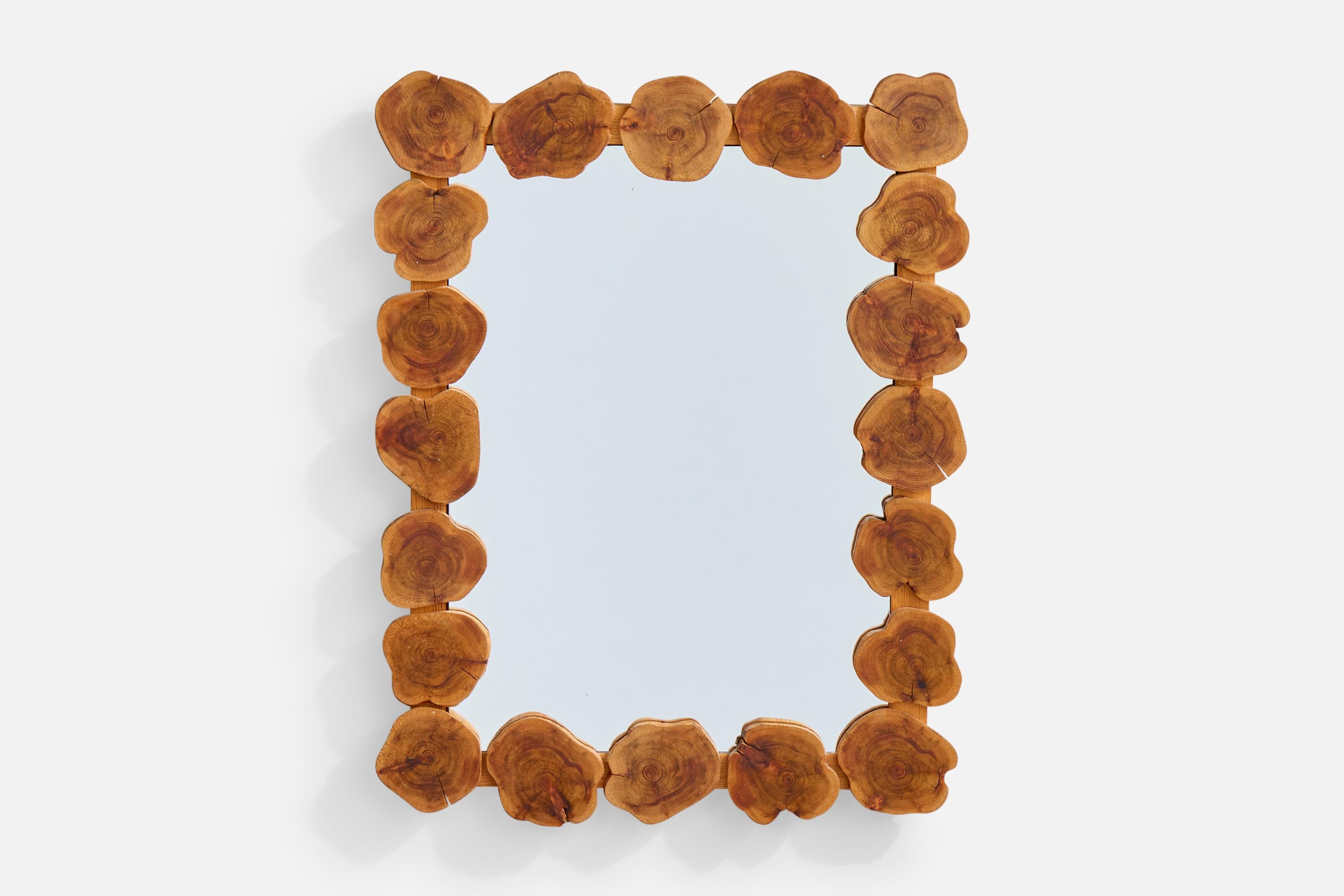 A wooden wall mirror designed and produced in Sweden, signed 