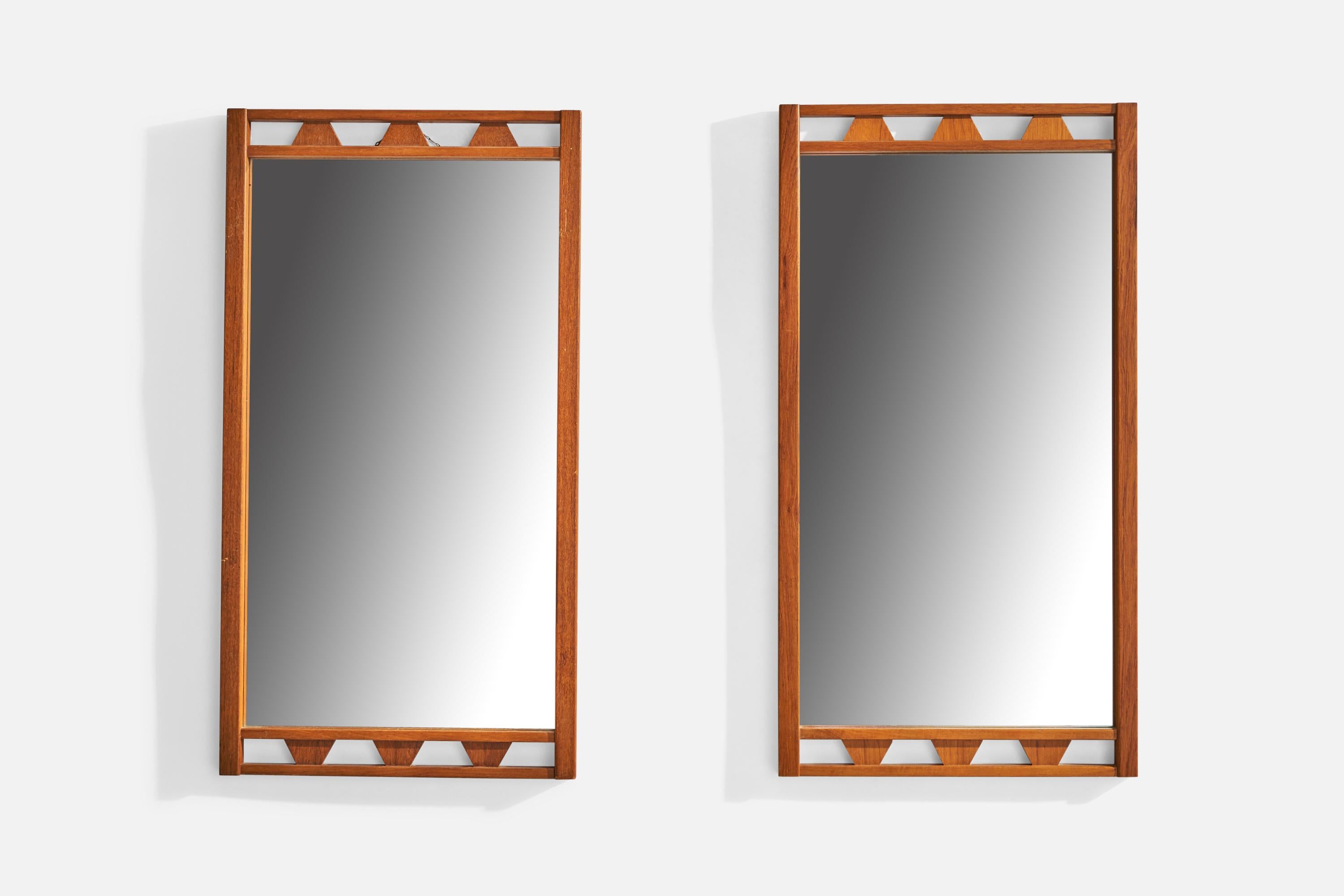 A pair of teak wall mirrors designed and produced in Sweden, c. 1950s.