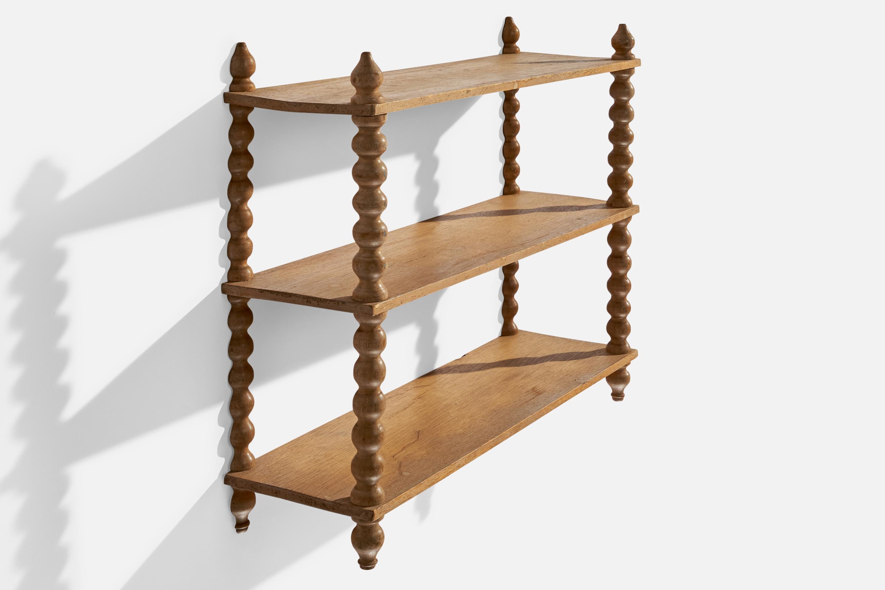 A wall mounted oak shelf designed and produced in Sweden, c. 1920s.