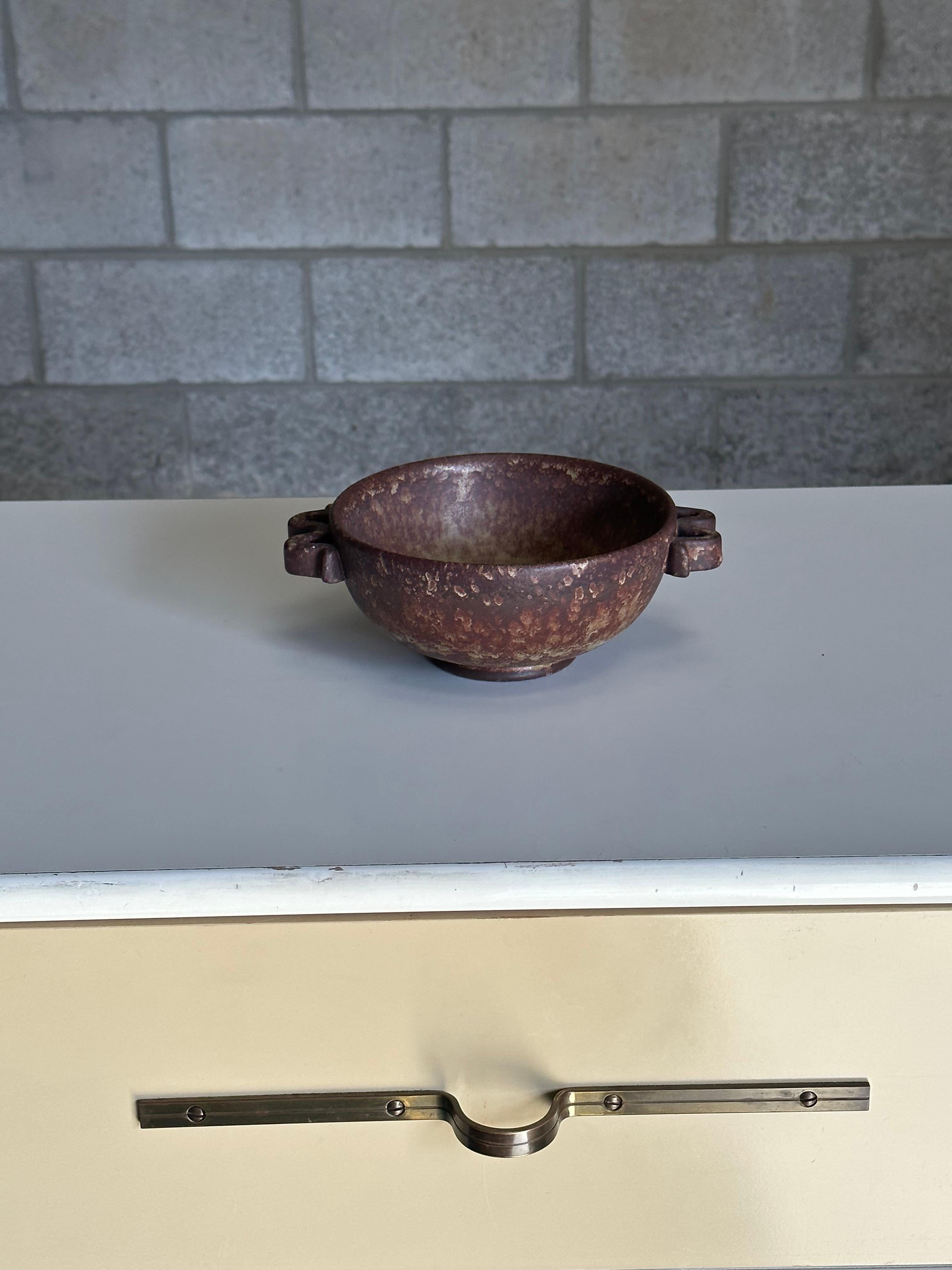 A unique and attractive stoneware bowl attributed to Höganäs Keramik. Great color palette and presence with tones of organic yellow, brown, and terra-cotta. 