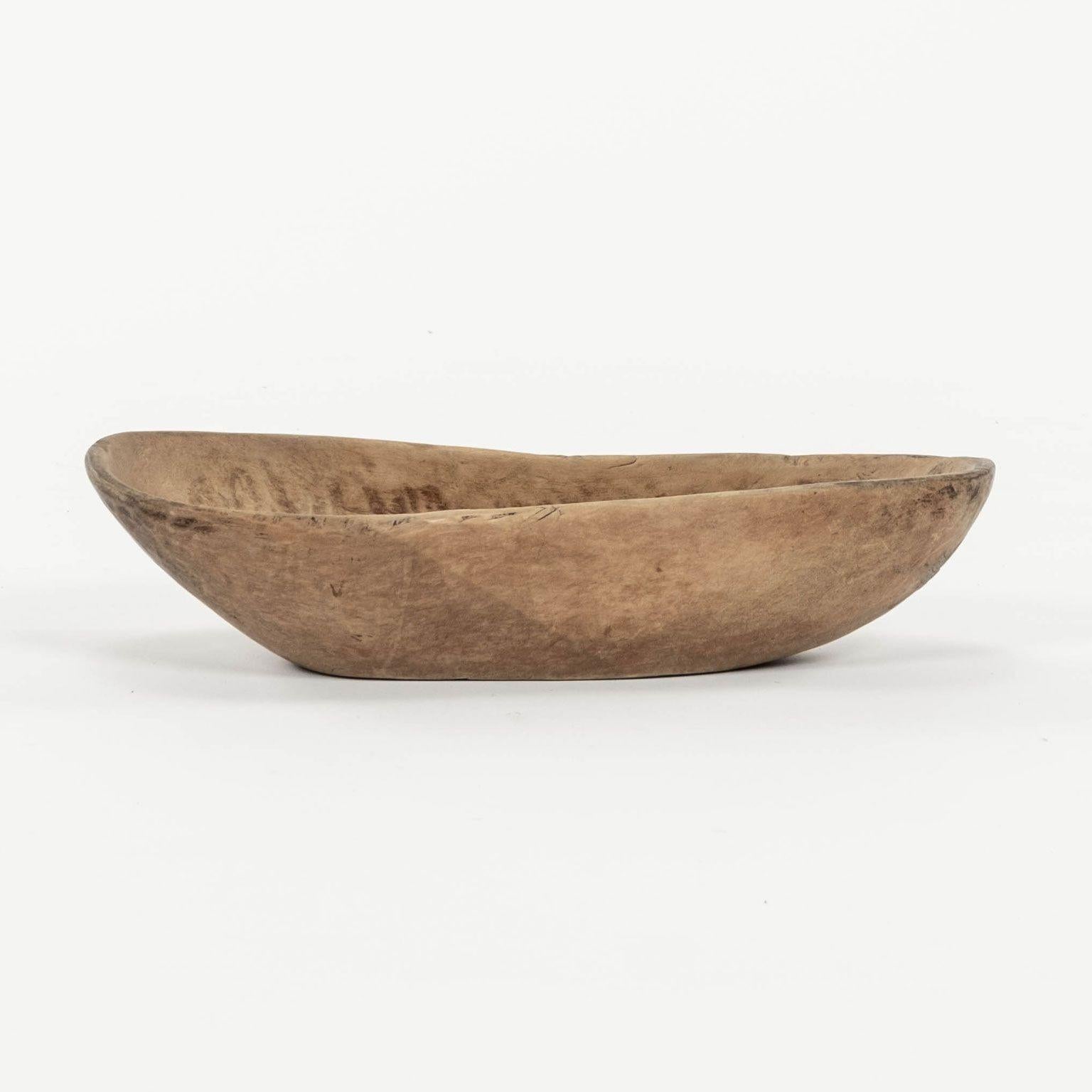 Swedish dugout branch shape trough bowl. Scrubbed, pale light brown color. Inscribed with runic characters underneath. Dates to early 19th century.

Note: Due to regional changes in humidity and climate during shipping, antique wood may shrink