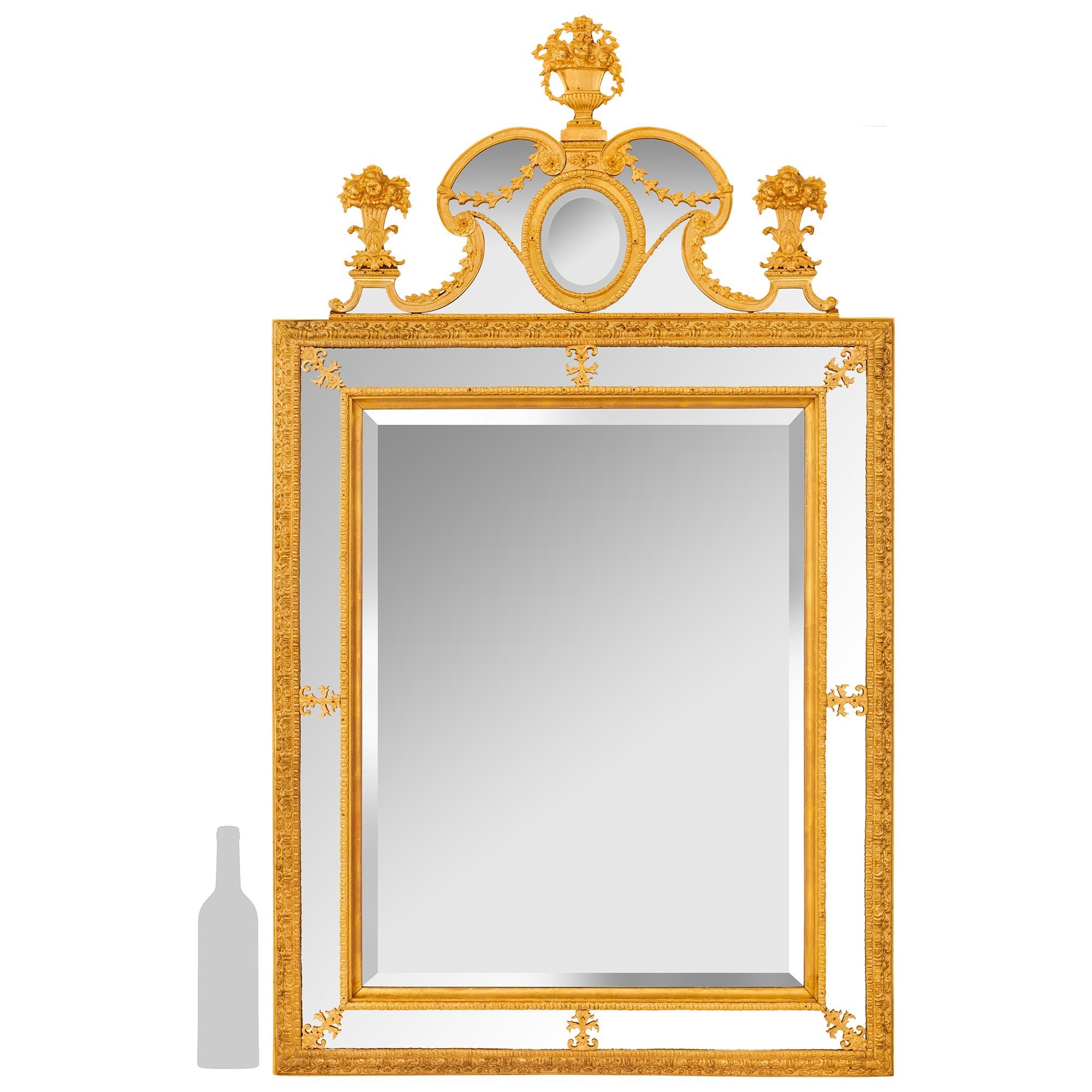 A sensational and high quality Swedish early 19th century Neo-Classical st. Ormolu mirror. The original central double framed beveled mirror plate is set within an Ormolu border with a foliate trim and palmettes accenting the center and corners of