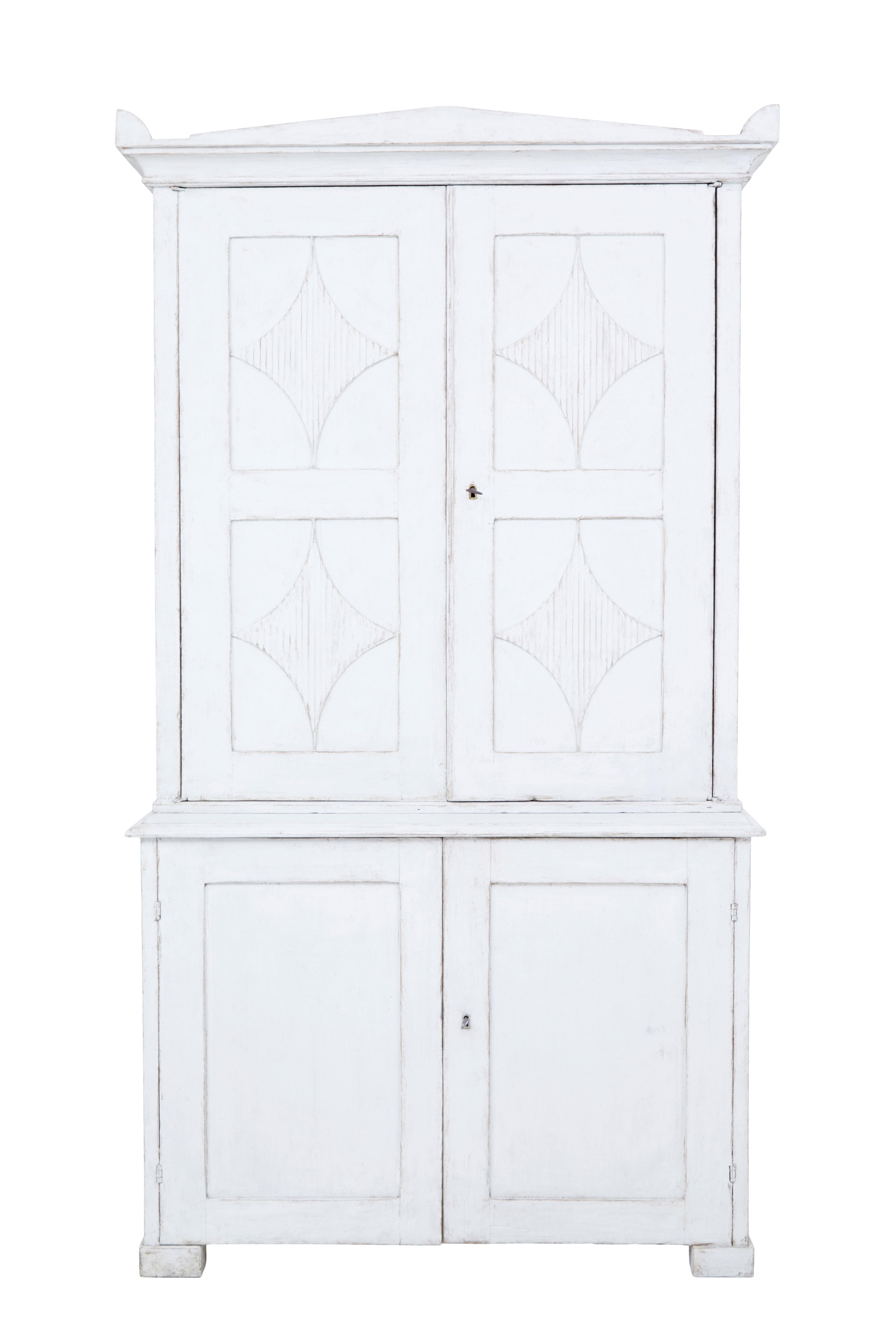 Swedish early 19th century painted cupboard circa 1820.

Fine quality 2 part cupboard, ideal for kitchen or multiple rooms around the house. Top section with architectural cornice, decorated with fluted recessed panels to the doors. Opening on the