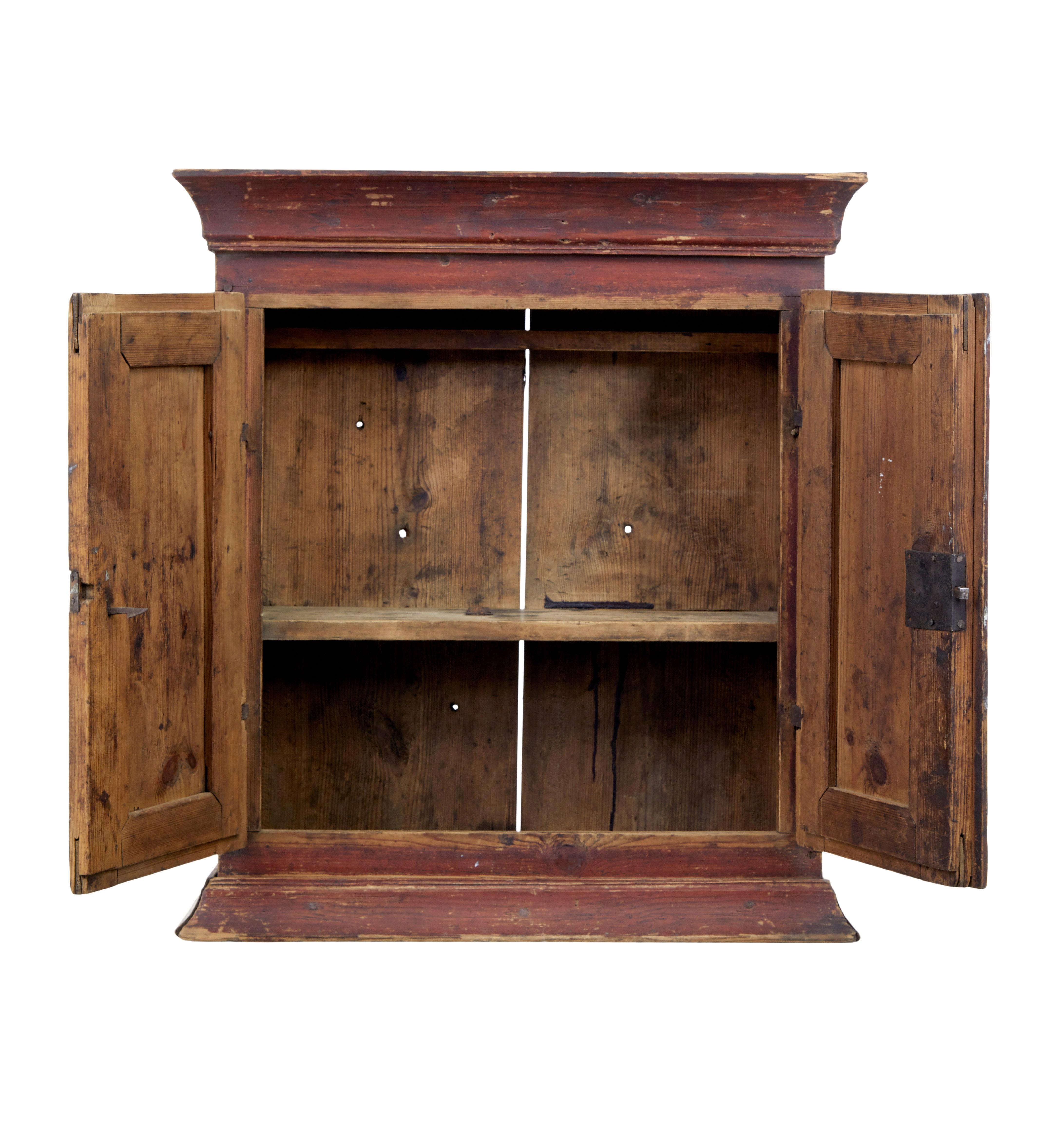 Swedish early 19th century painted pine wall cupboard circa 1820.

We are pleased to offer this 200 year old wall cupboard in original condition.

Presented in it's original paint.  Cornice around the top and bottom edgem, with double door's which
