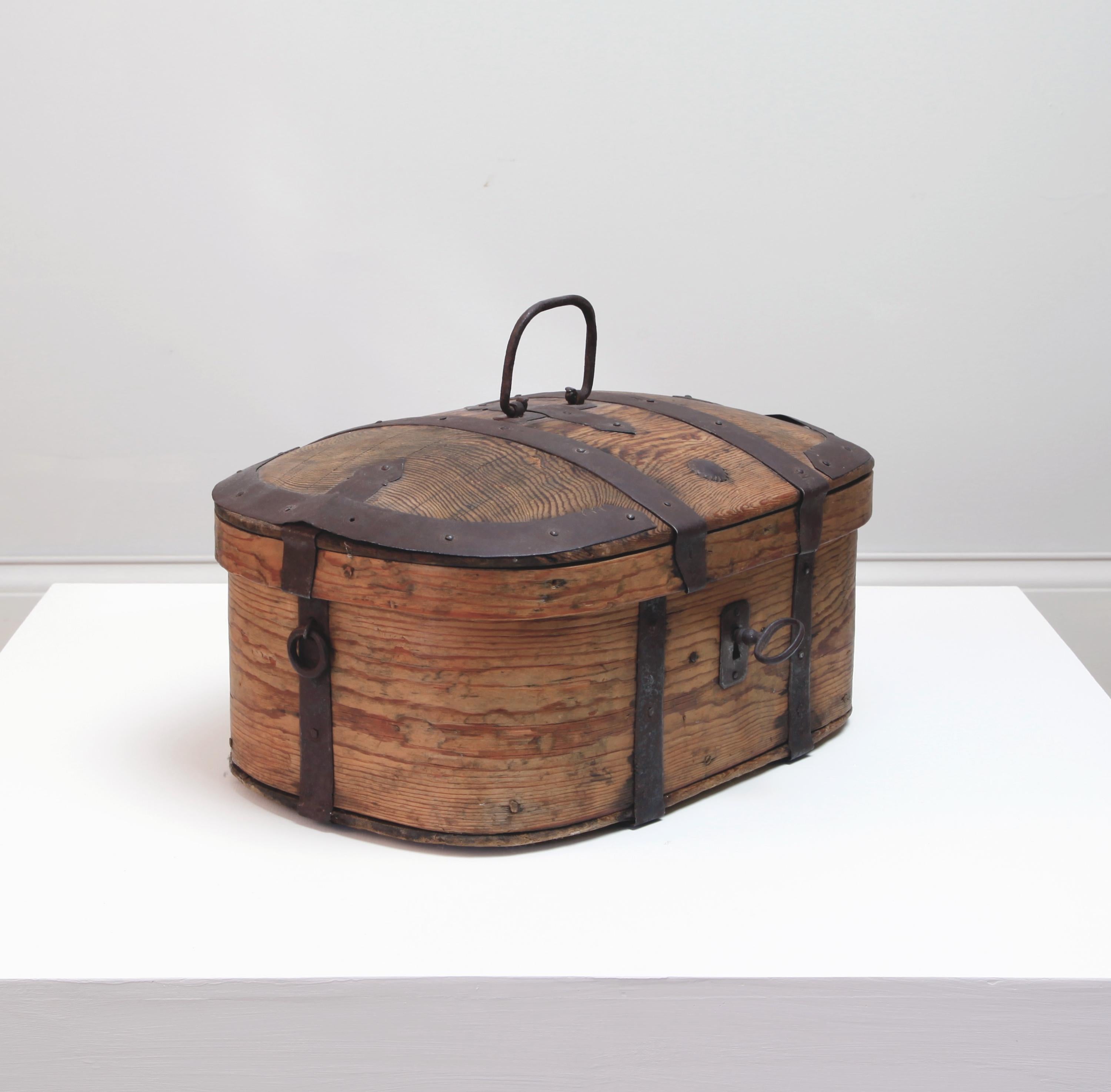 A finely-built and wonderfully rustic, small storage chest with original iron hardware and key. Containers of this kind were made for the storage of small comestibles.