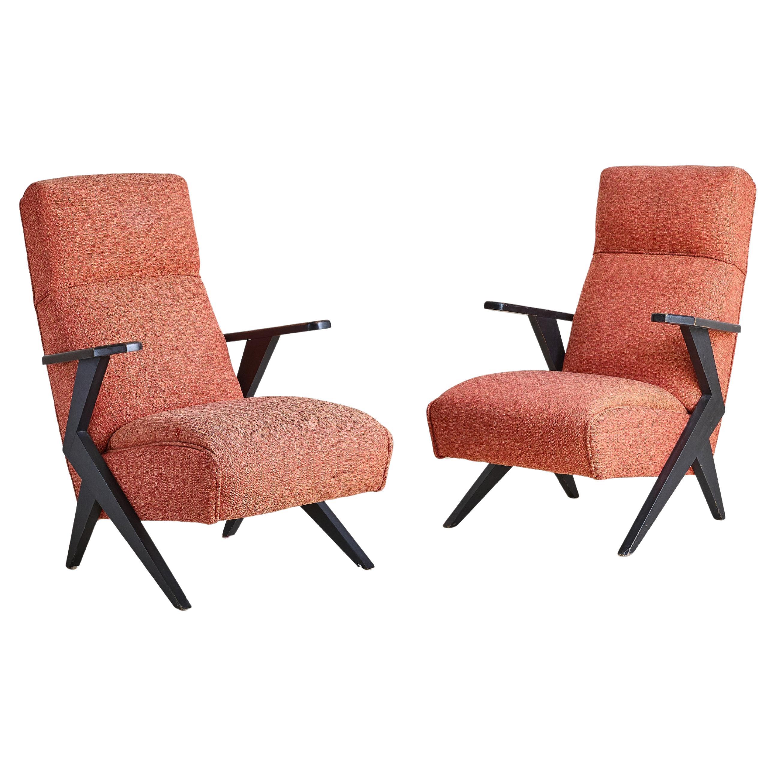 Sold and priced individually.

A 1950s Swedish modern low-profile lounge chair, defined by its sculptural, ebonized wood frame. With dramatic angled arms and a softly contoured, reclined back, it’s the perfect seat for unwinding. We elected to keep