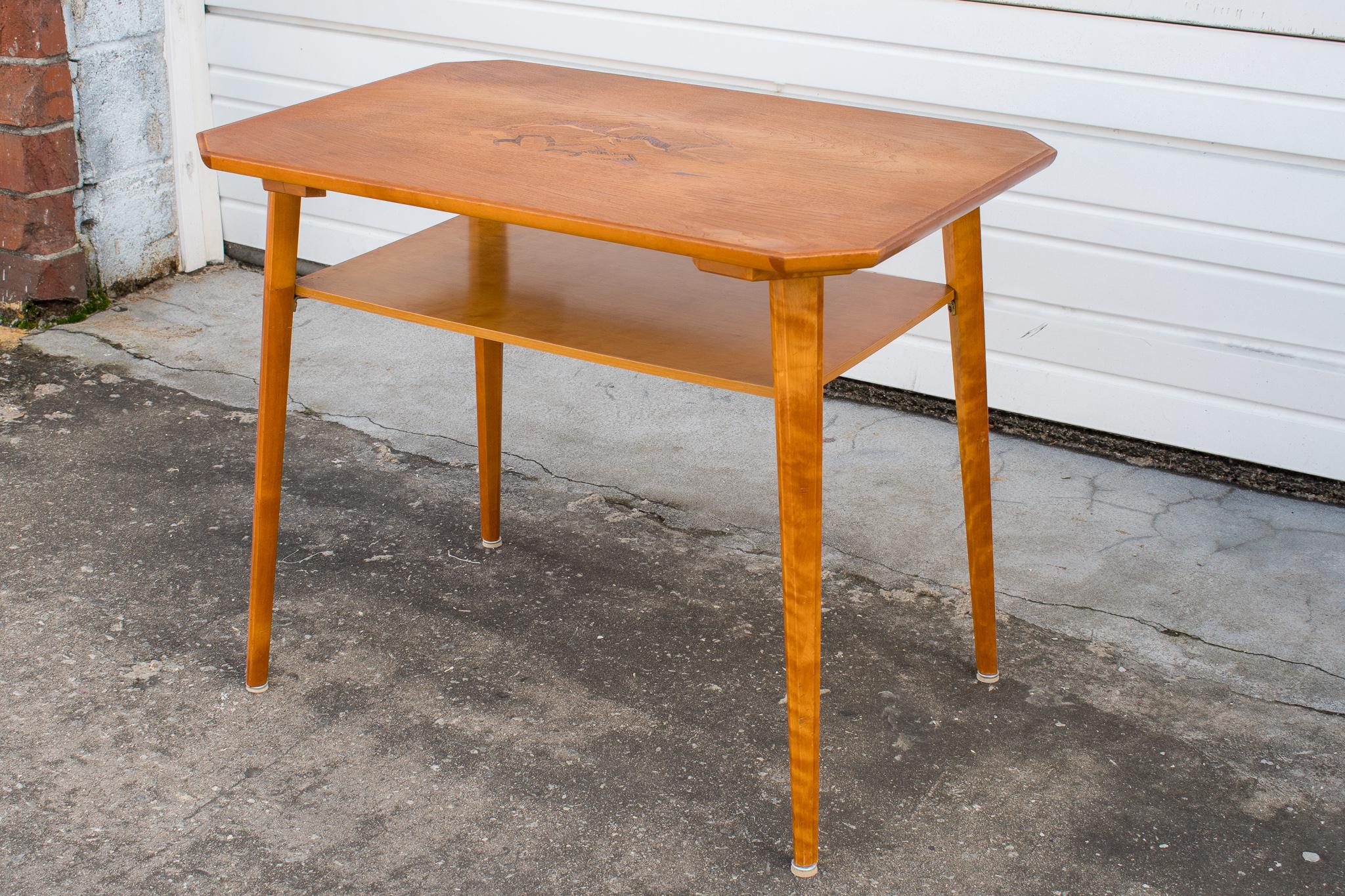 Swedish Modern side, end, or coffee table with shelf. Details include clipped corners, tapered legs, and inlay of rosewood, jacaranda, and mahogany depicting two deer.