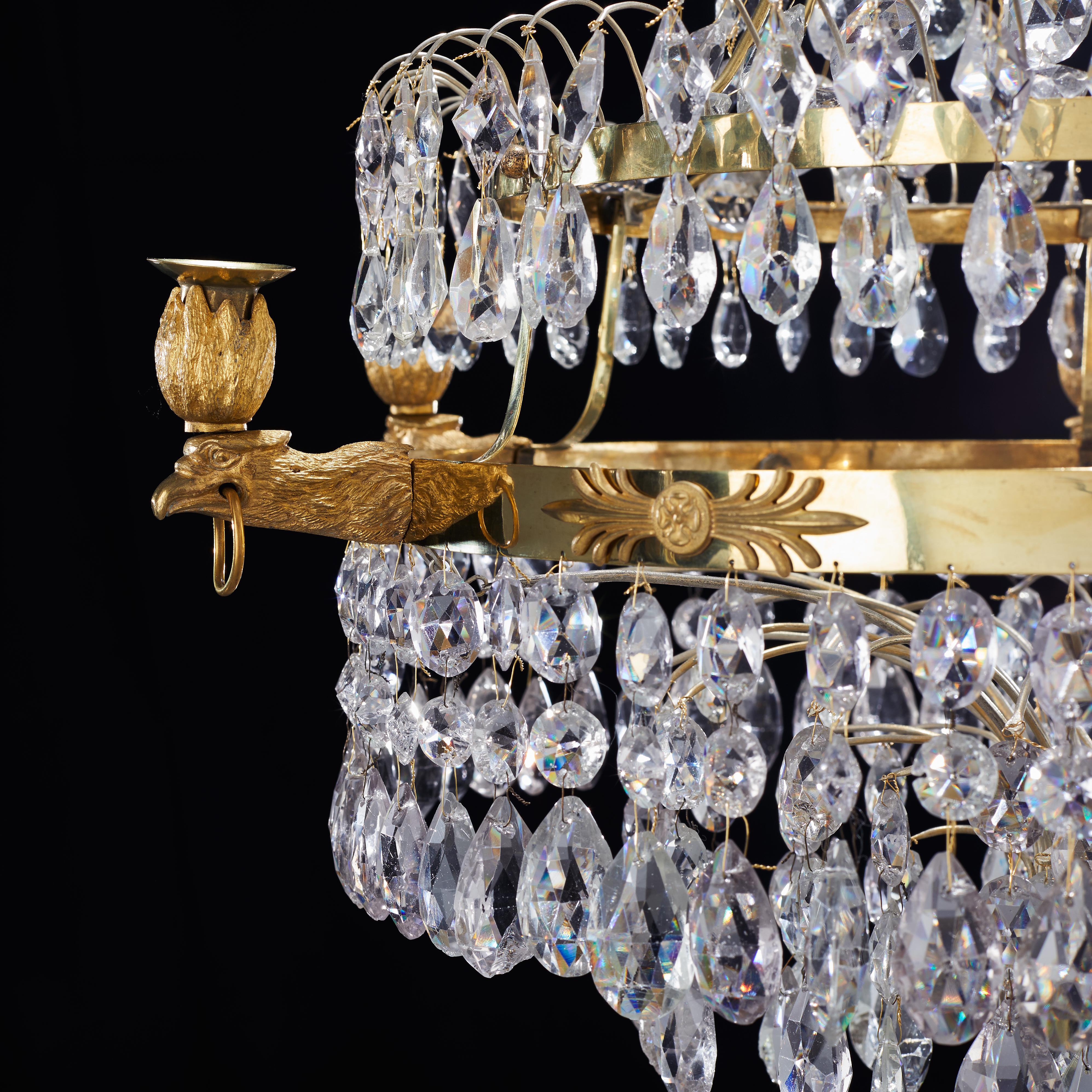 An unusual Swedish crystal and gilt bronze Empire chandelier made in Stockholm, early 19th century. 6 candles plus 1 in the middle.