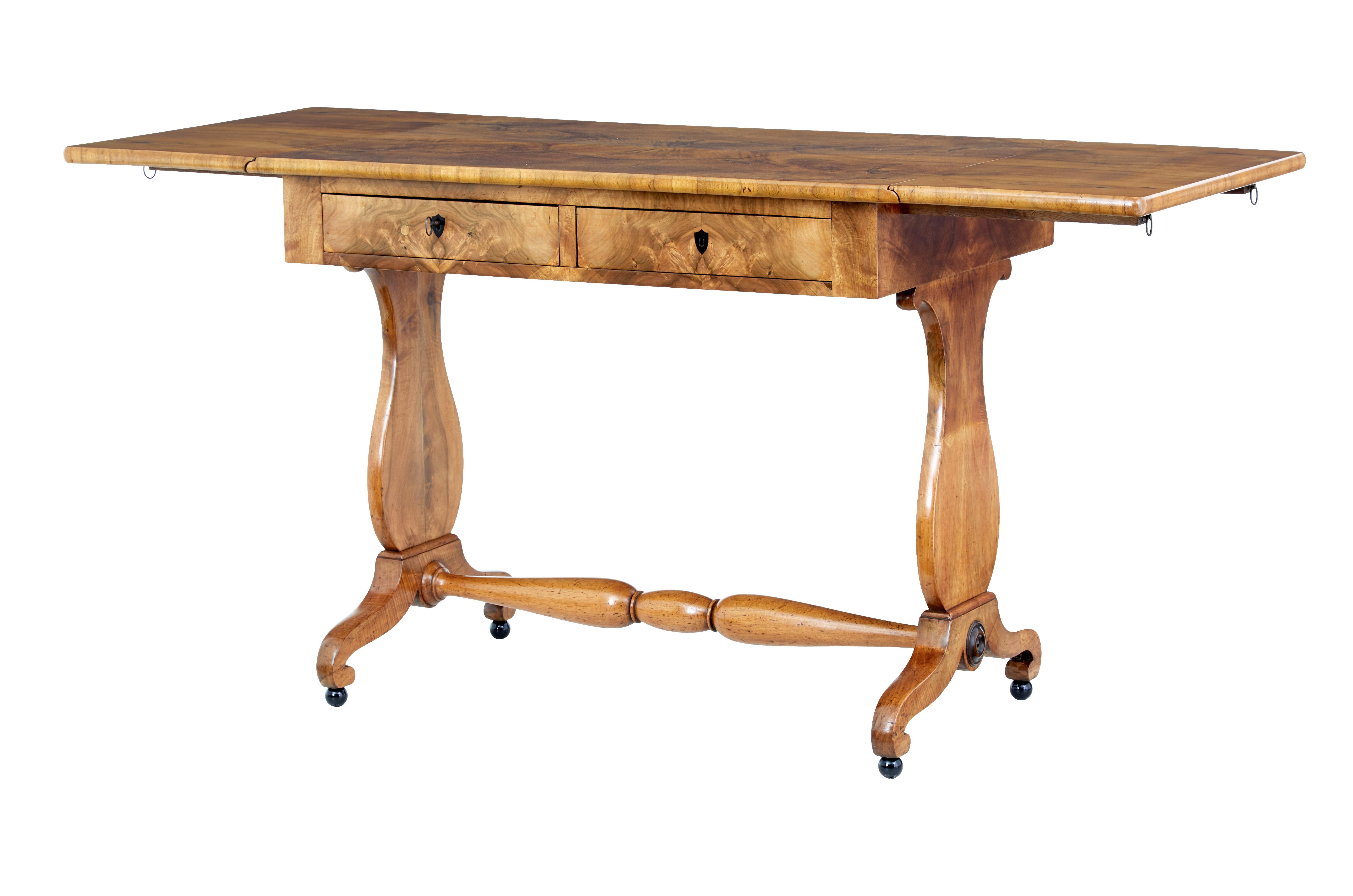 Swedish 1870s Empire Revival birch wood sofa table with drop leaves, butterfly veneer and carved legs. Bask in the elegance of the Empire Revival era with this gorgeous Swedish 19th century Empire Revival sofa Table, circa 1870. Masterfully crafted,