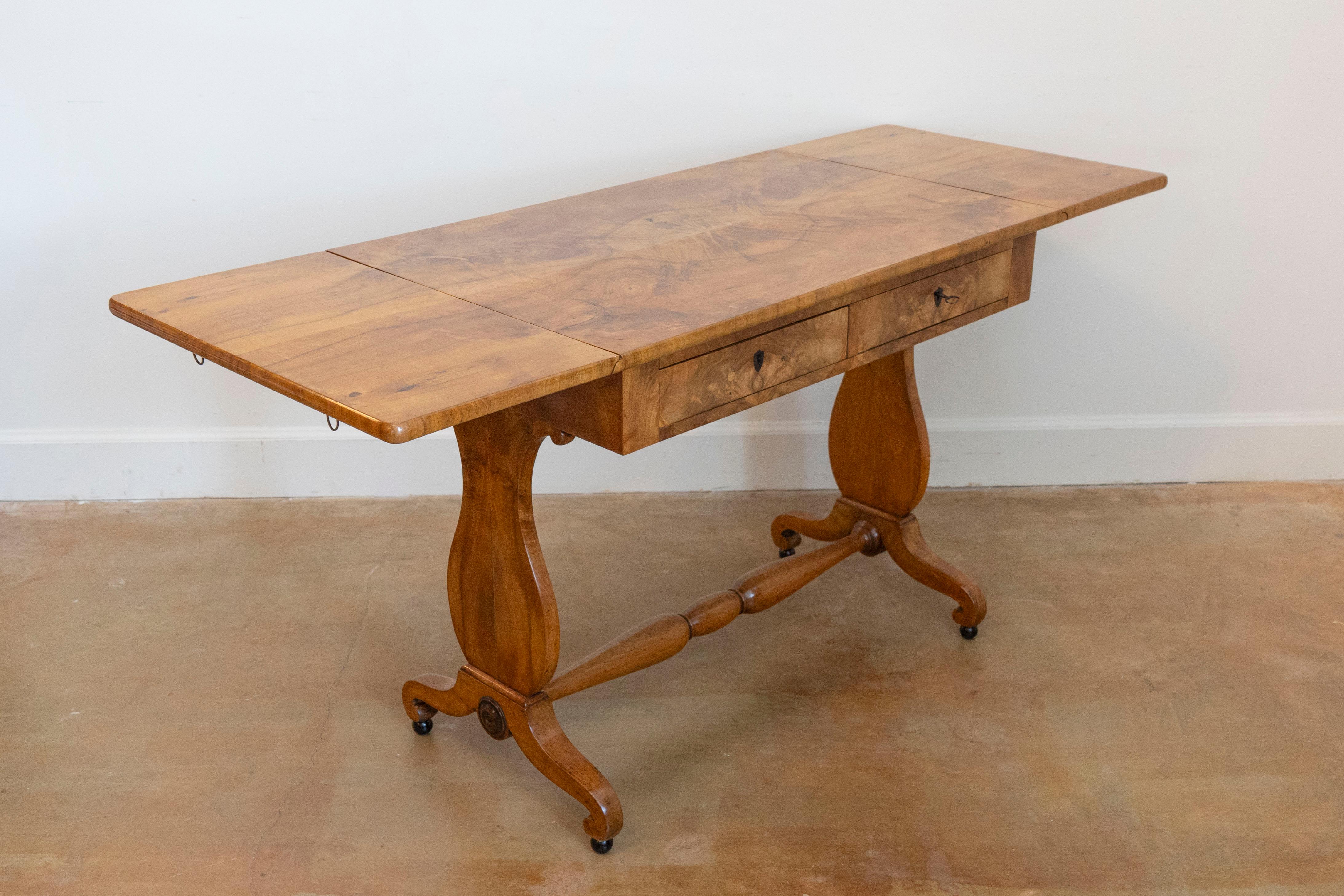 Swedish 1870s Empire Revival birch wood sofa table with drop leaves, butterfly veneer and carved legs. Bask in the elegance of the Empire Revival era with this gorgeous Swedish 19th century Empire Revival sofa Table, circa 1870. Masterfully crafted,