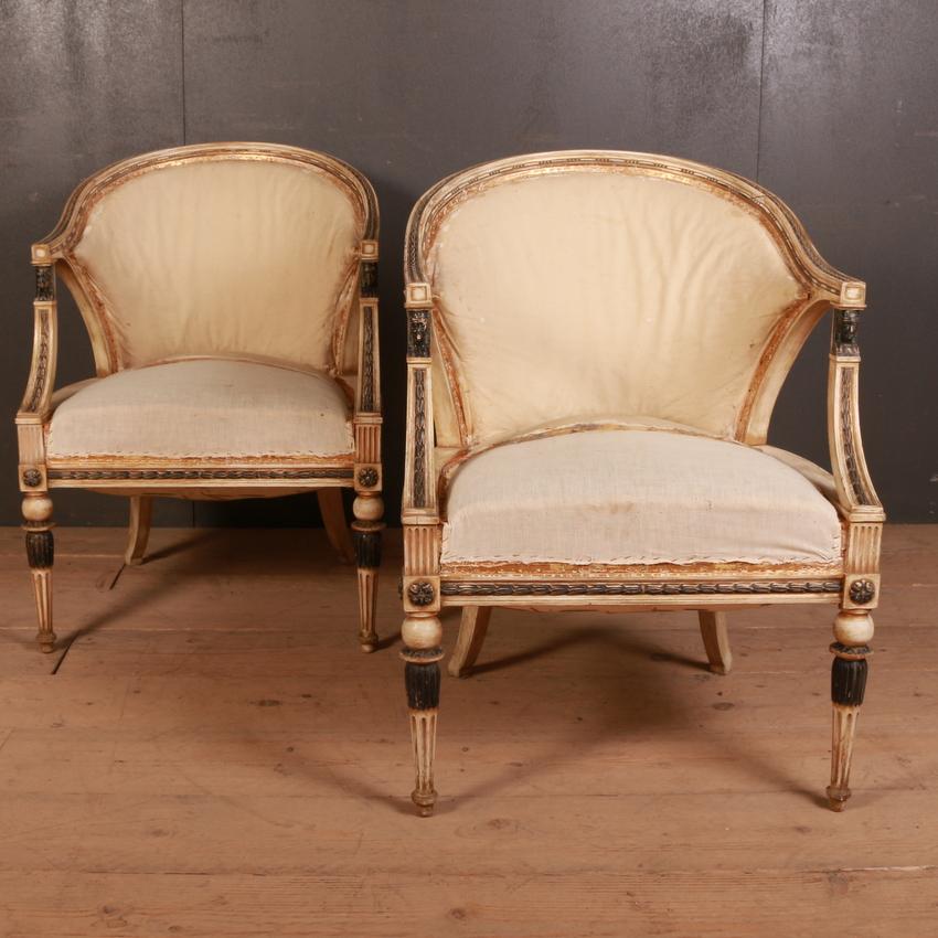 Pair of late 19th century Swedish Empire style barrel back armchairs decorated with carved Egyptian heads raised on fluted turned legs decorated with acanthus leaves. Original paint with traces of gilt. Superb quality and very comfy, 1890

Seat