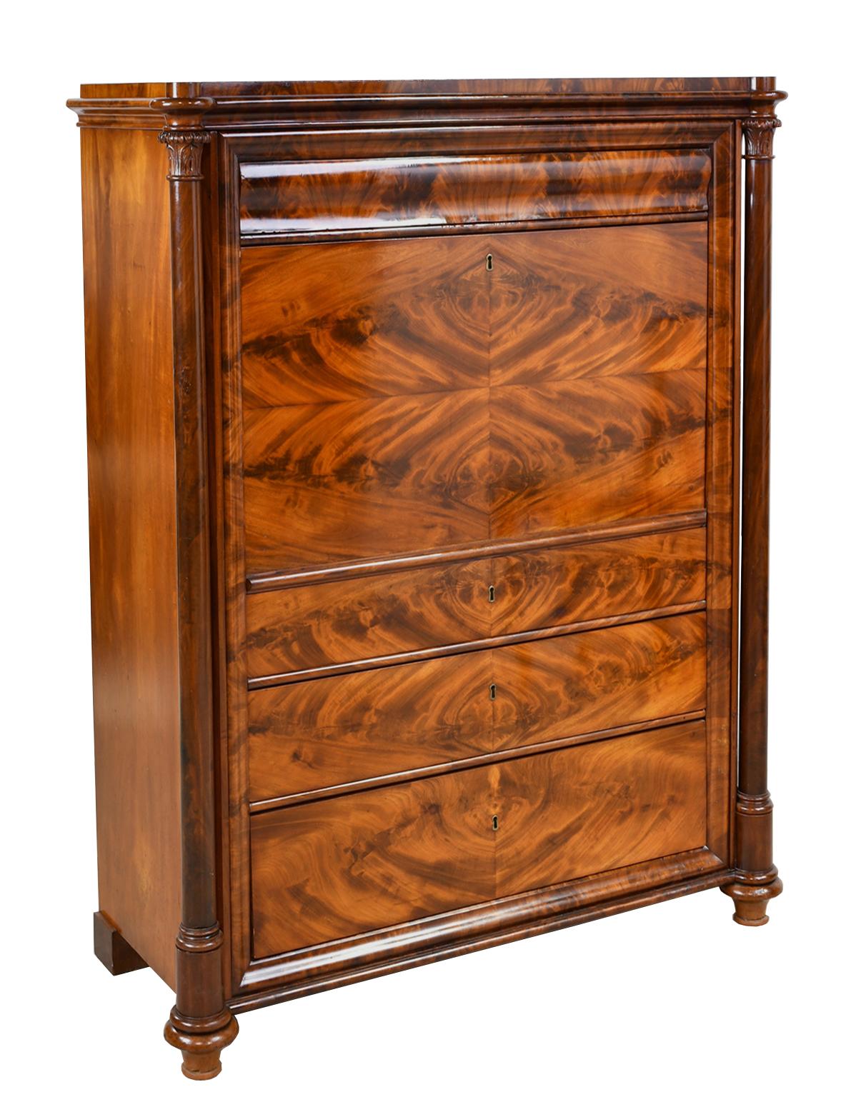 A very beautiful and finely-crafted secretary in West Indies mahogany with book-matched crotch mahogany along the entire front. There are three graduated storage drawers below the fall-front, and one above which opens with a secret button. The desk