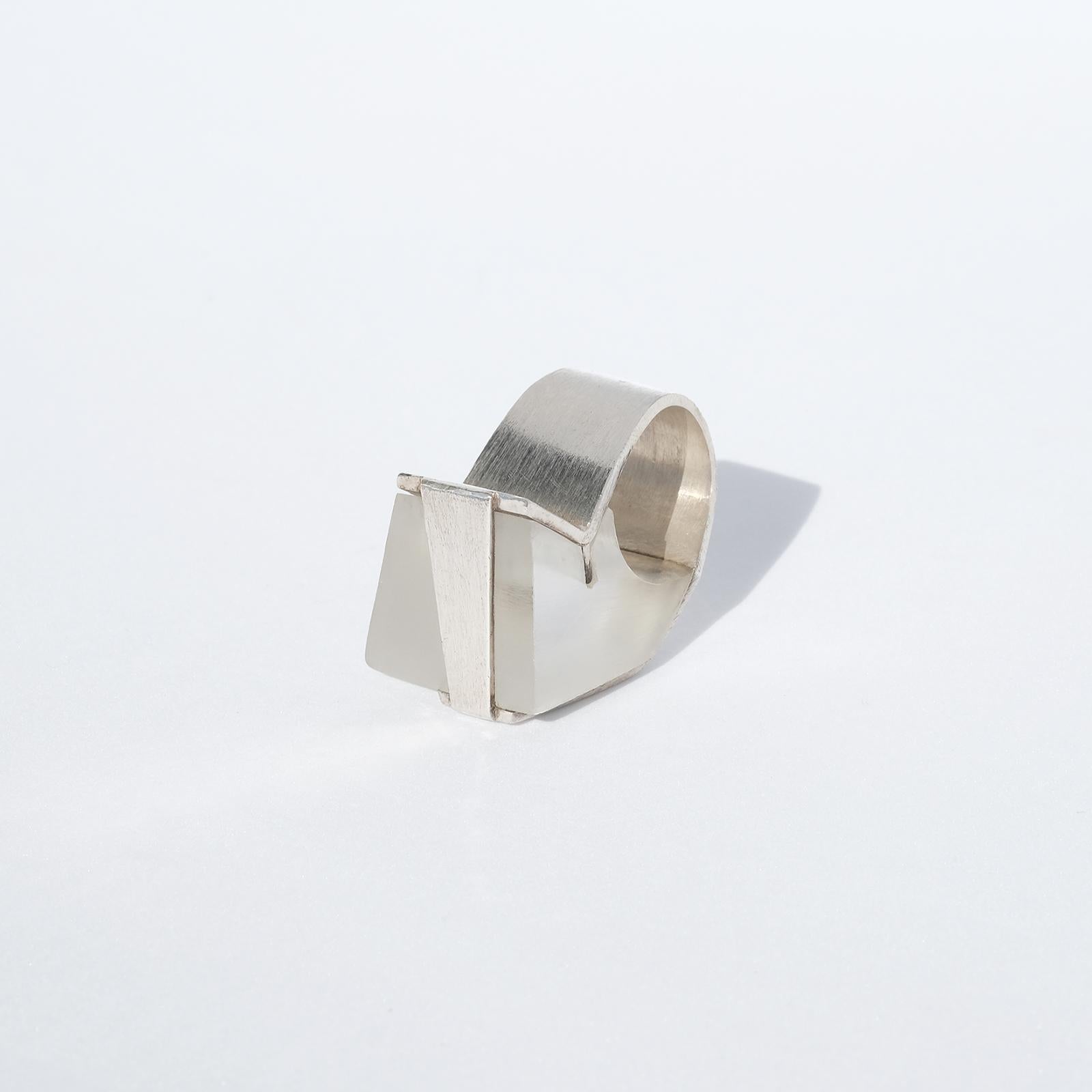 This sterling silver and white acrylic ring has, with its geometrical shapes and its material, a very avant-garde look which could be described as a piece of jewelery originating from the brutalist culture. Its handcarft is amazing! 

It is of a