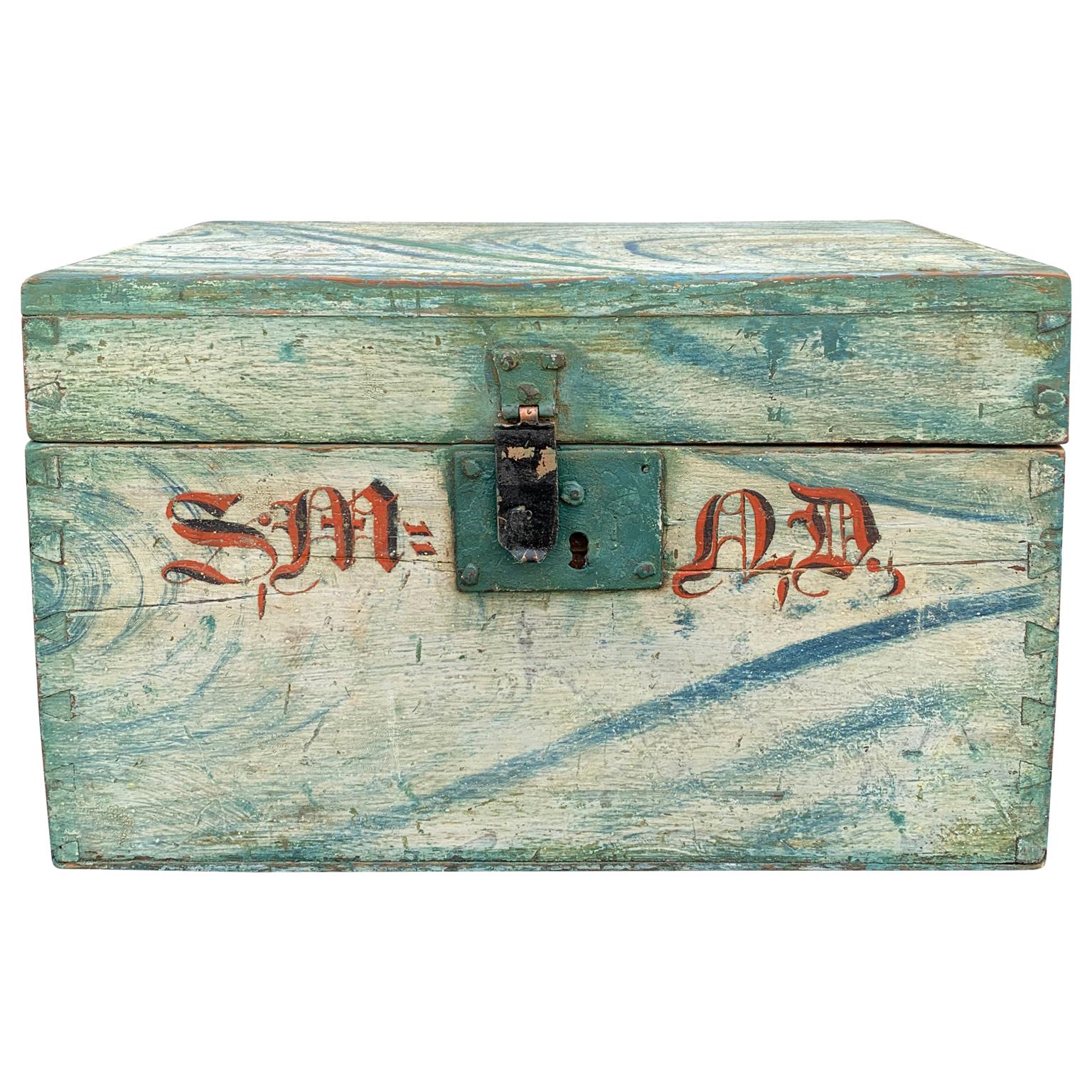 Early 19th century hand painted folk art box in original blue, white and greenish faux marble decorations, circa 1825.
The late Empire box is also decorated with a monogram on the front side and retains its original metal hardware. It as belonged to