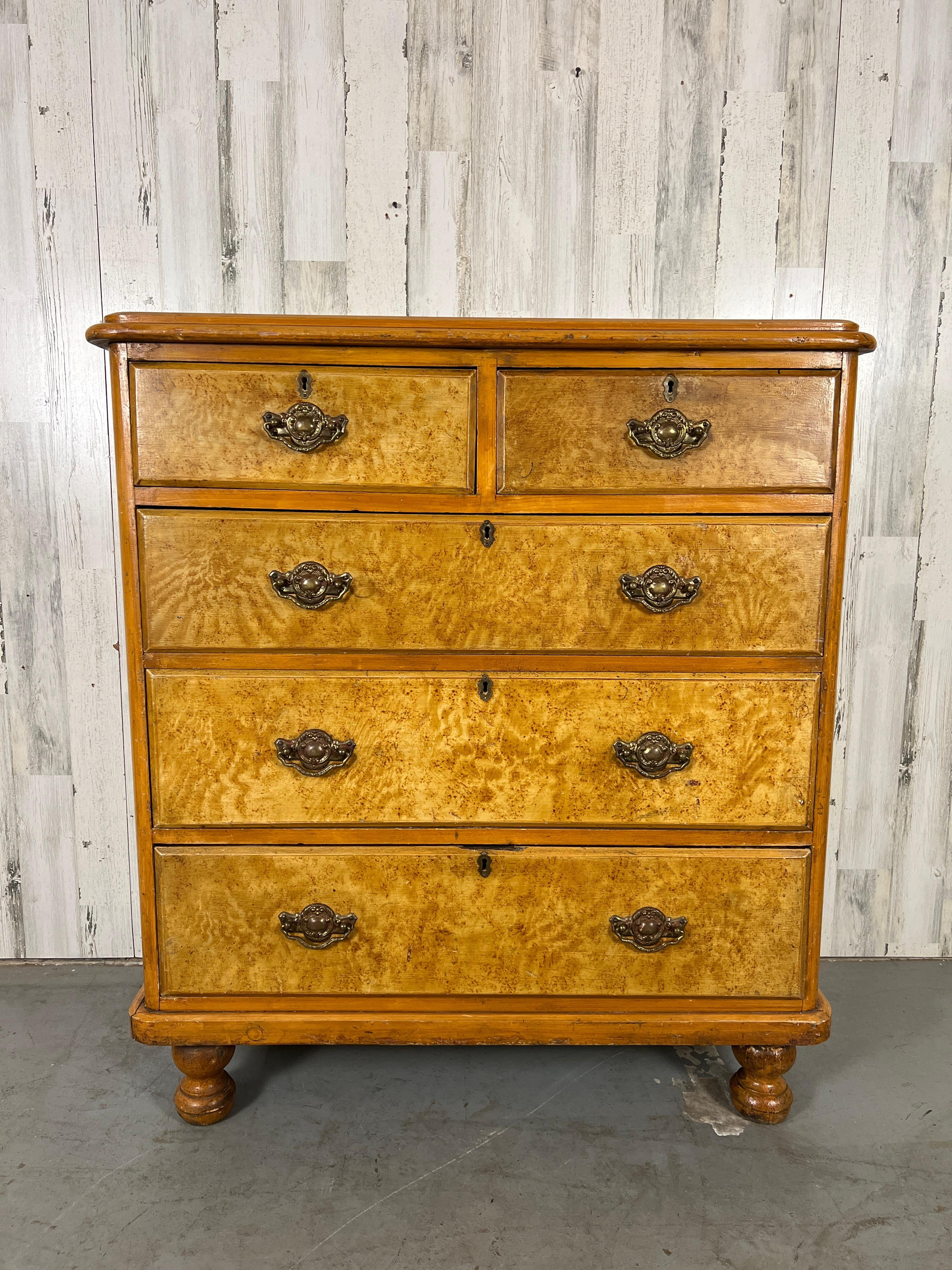 Solid pine with hand painted faux grain design and faux burl on the drawer fronts. Rococo Revival drawer pulls add to this timeless style.