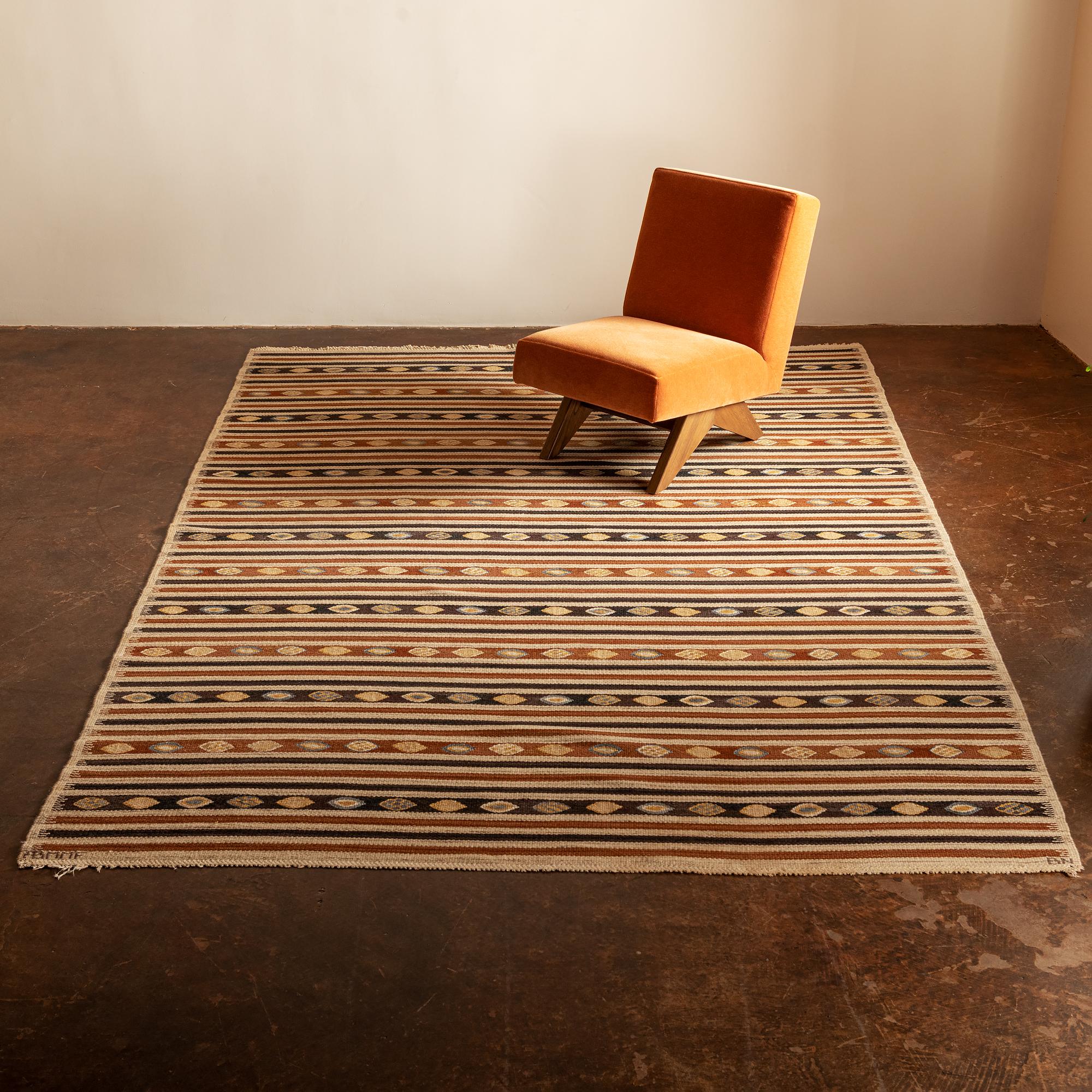 A classic Swedish Gobeläng designed by Barbro Nilsson in 1946. This original rug from the studio of Märta Måås-Fjetterstrom was handwoven in wool on linen warp in cognac, coffee, sky blue and ochre.  A design classic. Signed BN, ABMMF, Bastad,