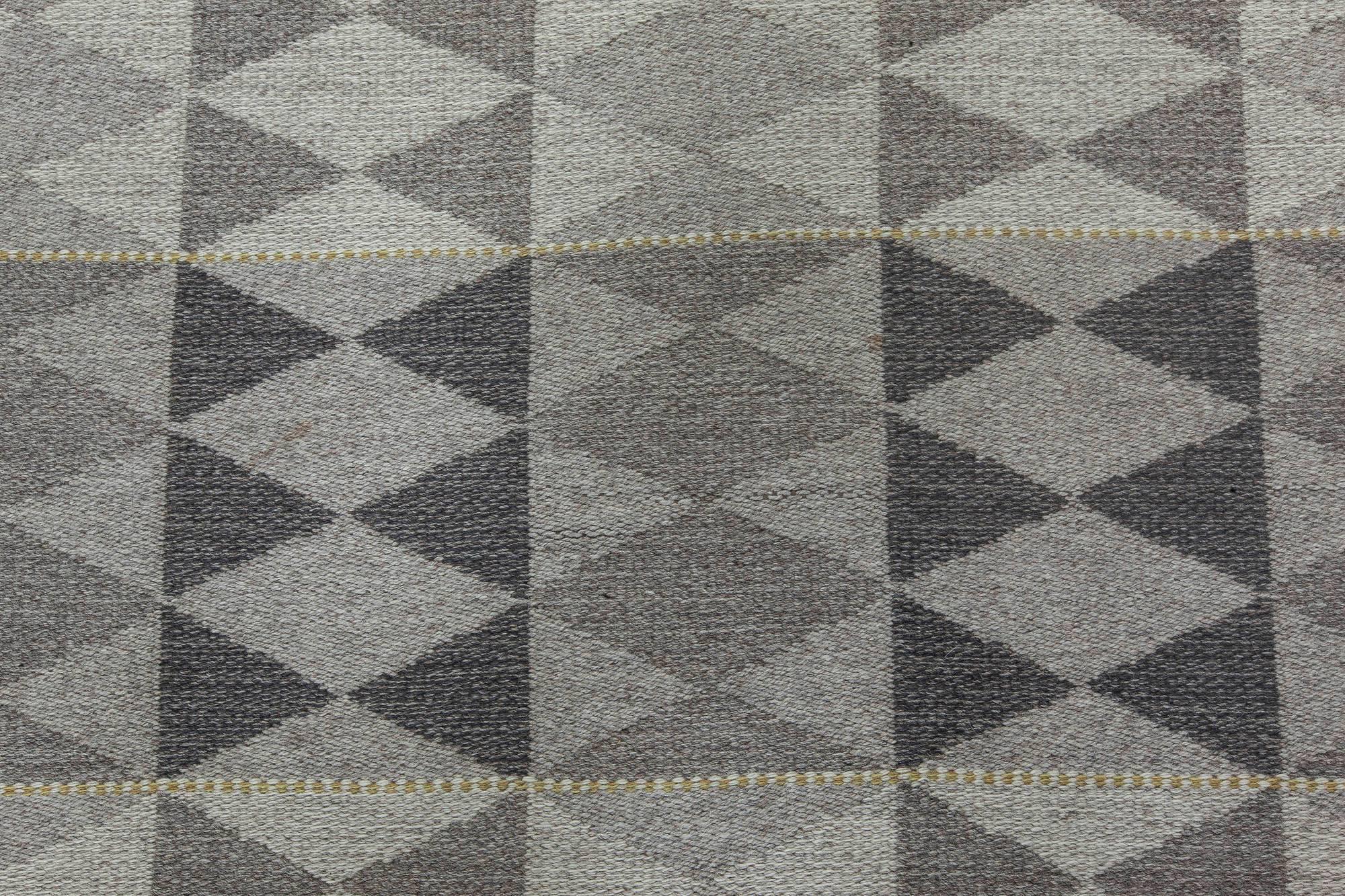 This luxurious Swedish rug hand-knotted with wool is an exquisite example of Scandinavian design. Peaceful pattern is flat-woven with an use of soily shades of fibers. Diamonds organized in vertical and horizontal rows covering the whole surface of