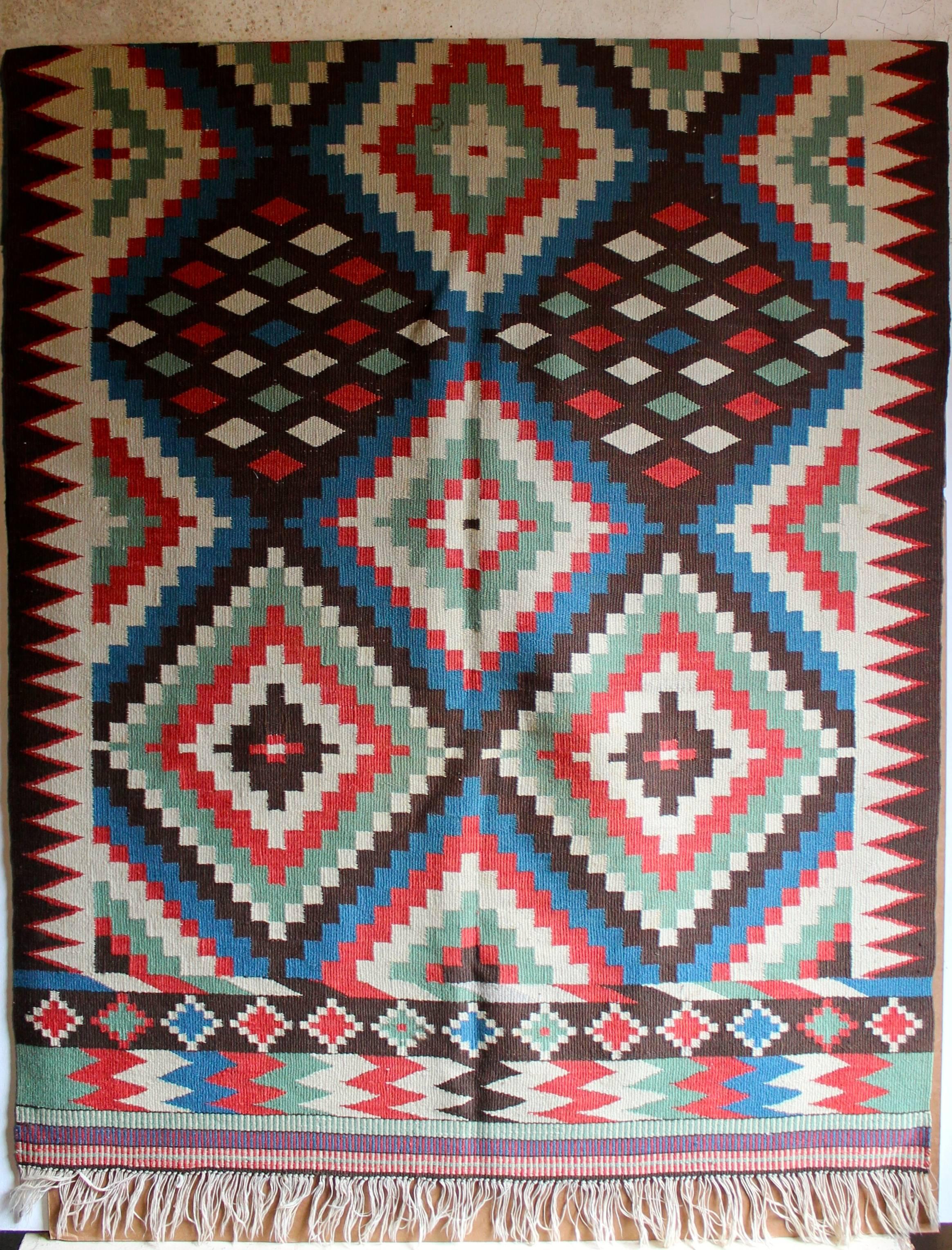 A large and dynamic rug or wall hanging.