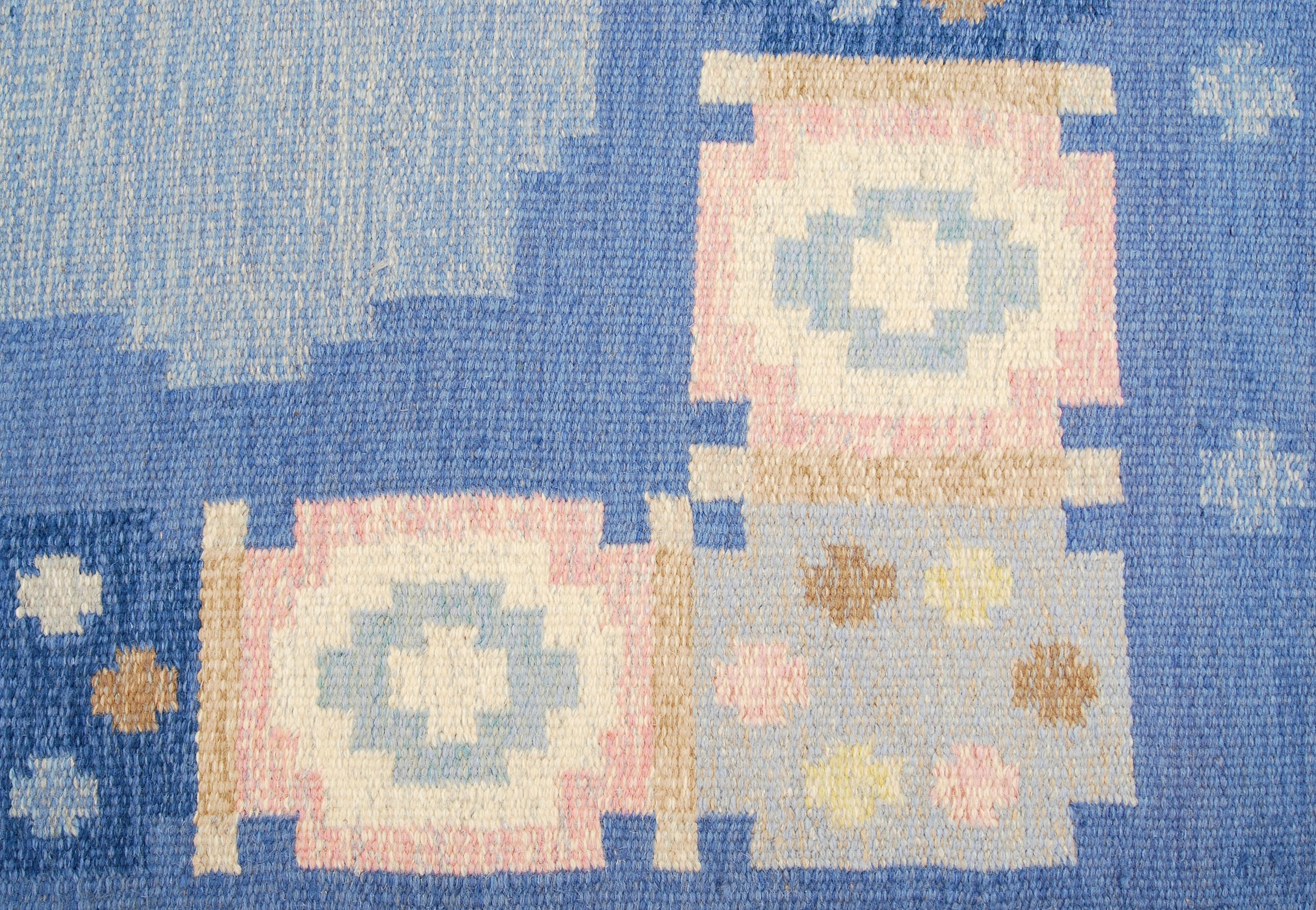Vintage Swedish flat-weave carpet by Anna Johanna Ångström. This example with fields of three different shades of blue, beige, white, brown, pink and yellow. Handwoven in wool and signed Å to the right hand corner. Professional water cleaned.