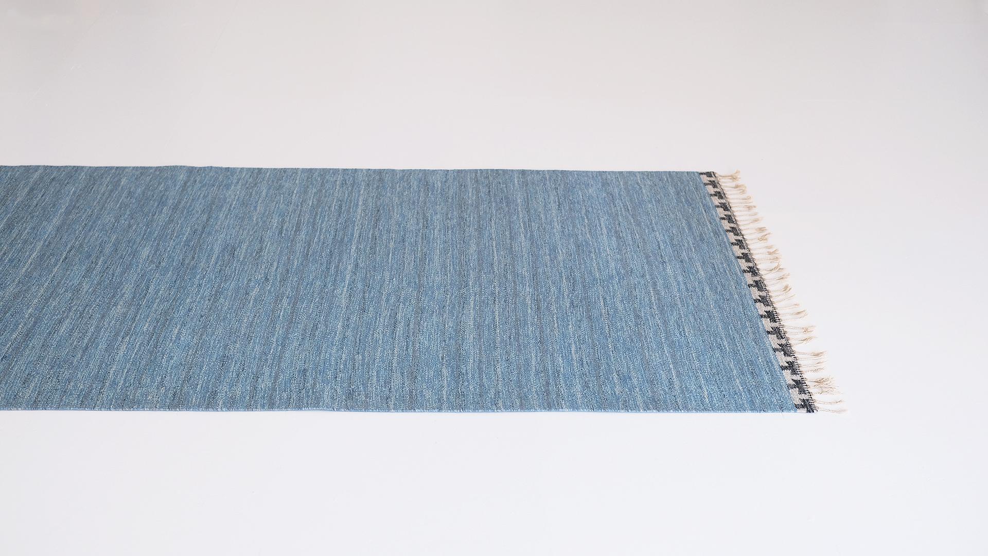 Beautiful Swedish flat-weave, Rolakan carpet by Rakel Carlander. Very simple blue mélange with signature black and grey edging. Very elegant piece in great original condition.
