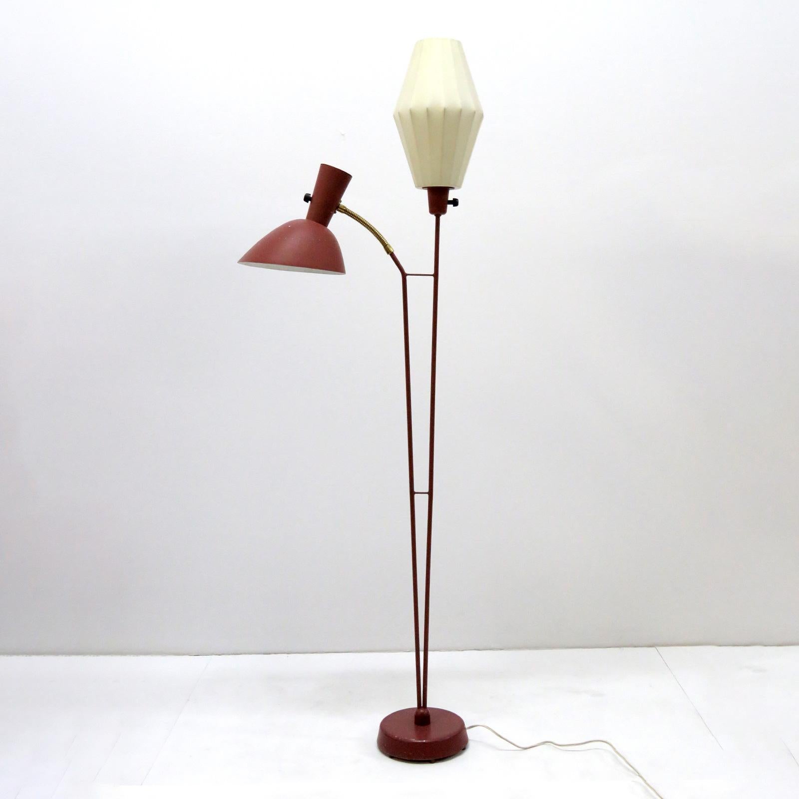Rare 1950s Swedish double arm floor lamp by Hans Bergström for Ateljé´ Lyktan in Åhus, Sweden, with one standing light with a resin cocoon shade and a down-light double cone maroon colored metal shade with flexible brass arm and perforations to the