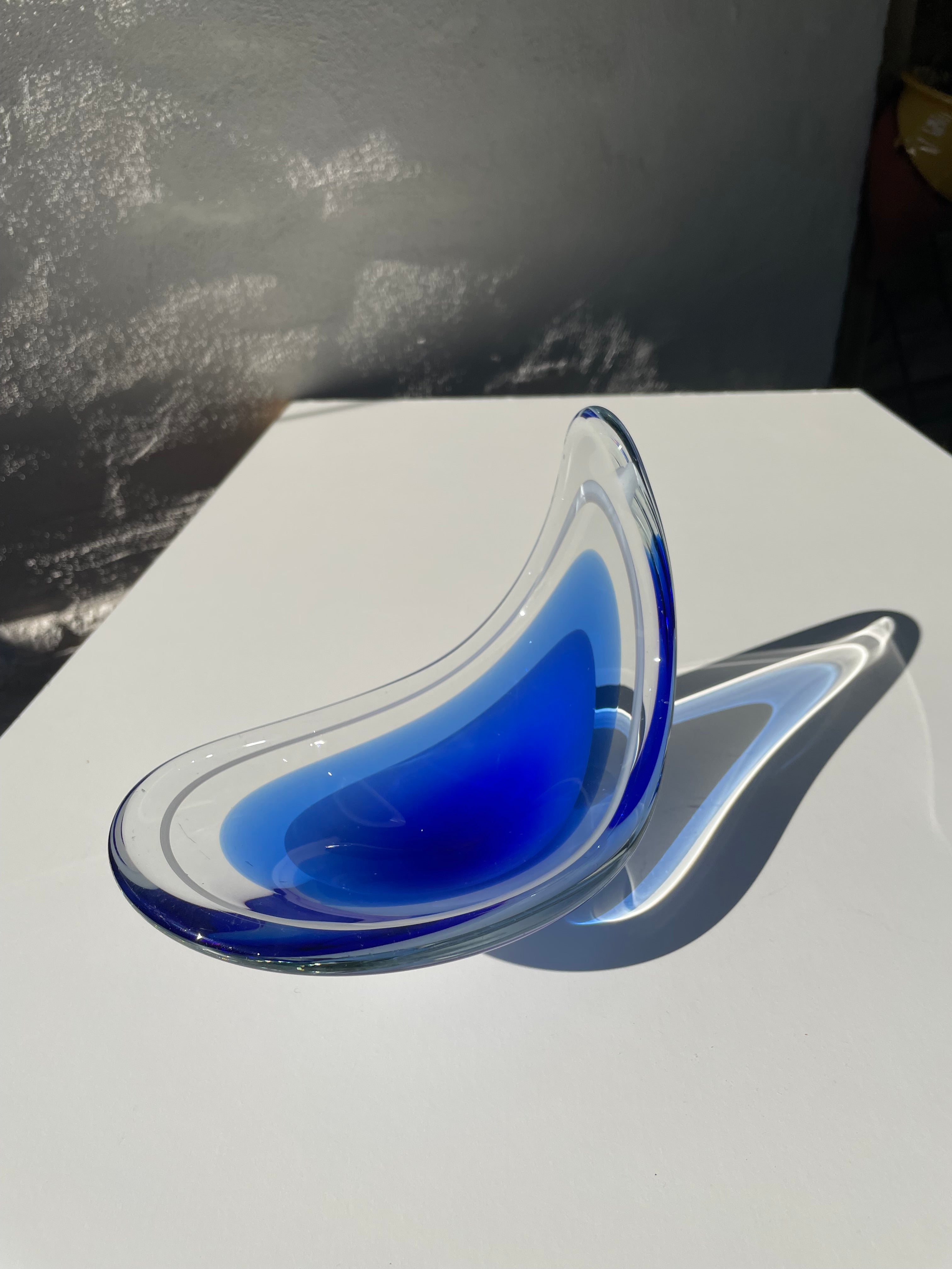 Vivid deep blue overlay art glass designed by Paul Kedelv for Swedish Flygsfors. A rare blue colored item in the Coquille series designed in 1956. Soft mouthblown shapes with one lifted side. Deep blue, translucent medium blue and solid clear glass
