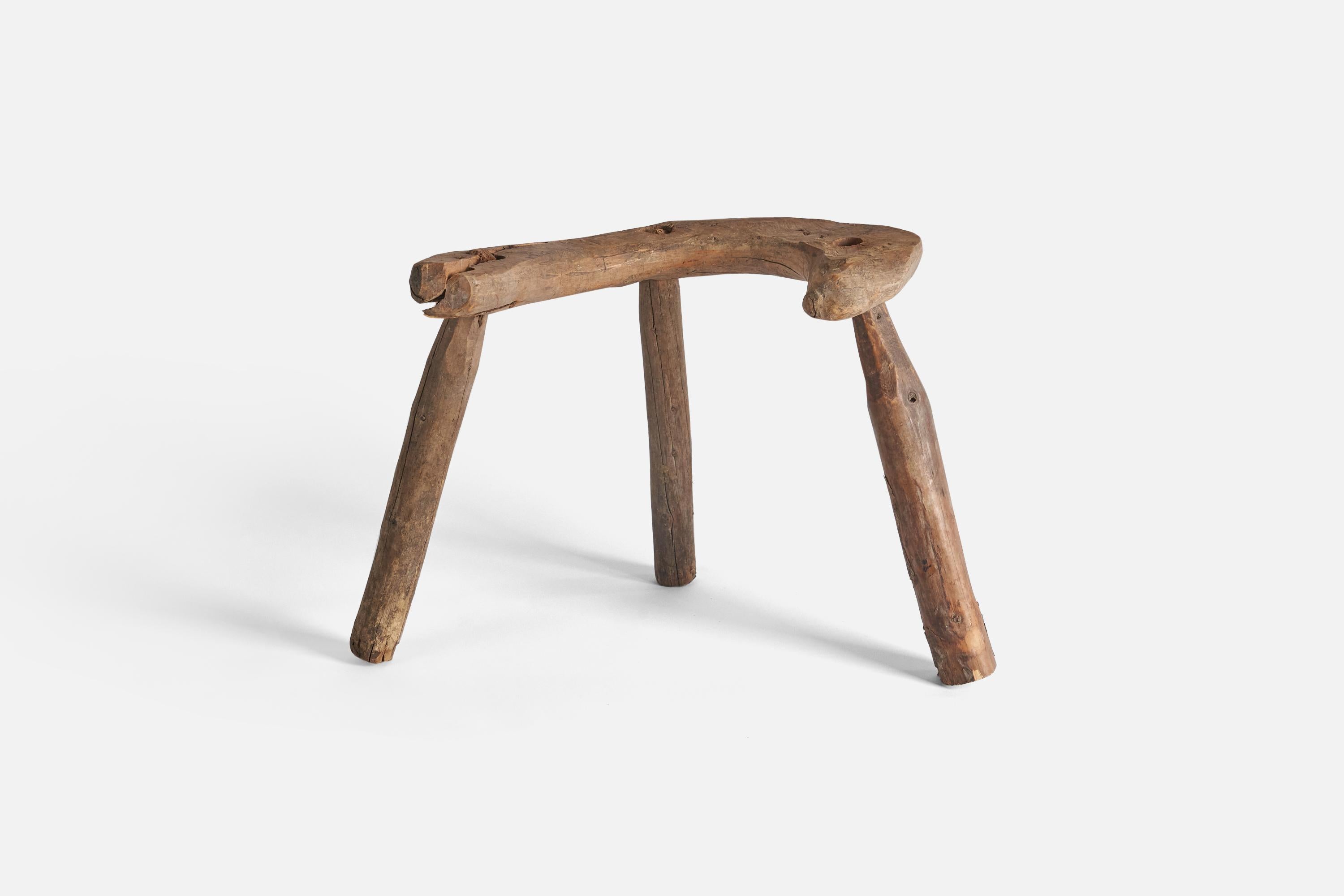 A wooden farmers stool produced in Sweden, 19th century.