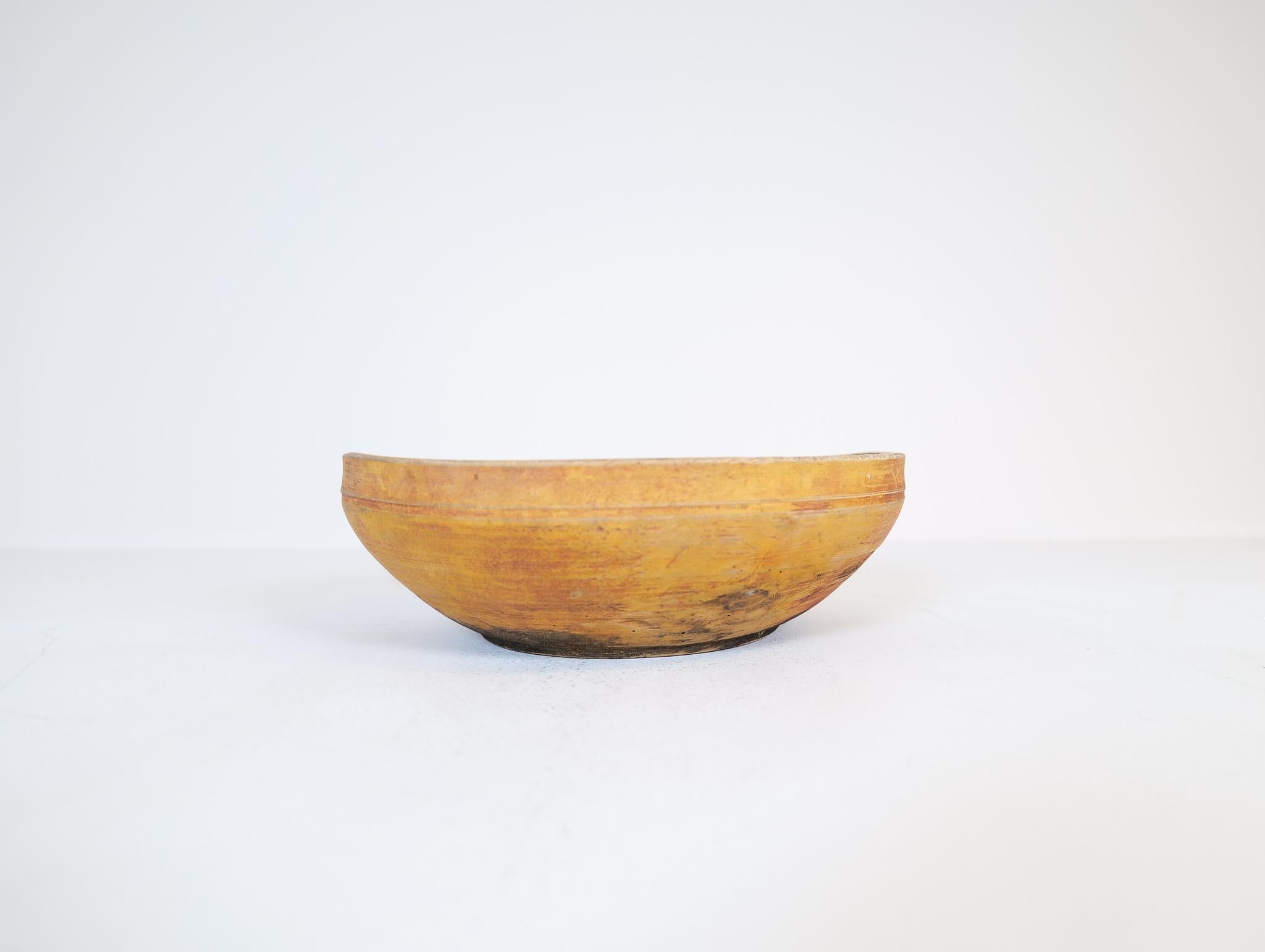 An antique and unique organic wooden bowl. With highly appealing patina, with traces of use. Produced in Sweden, 19th century. This one with great patinated red color on it. 
These bowls where very important for many families; therefore, they were